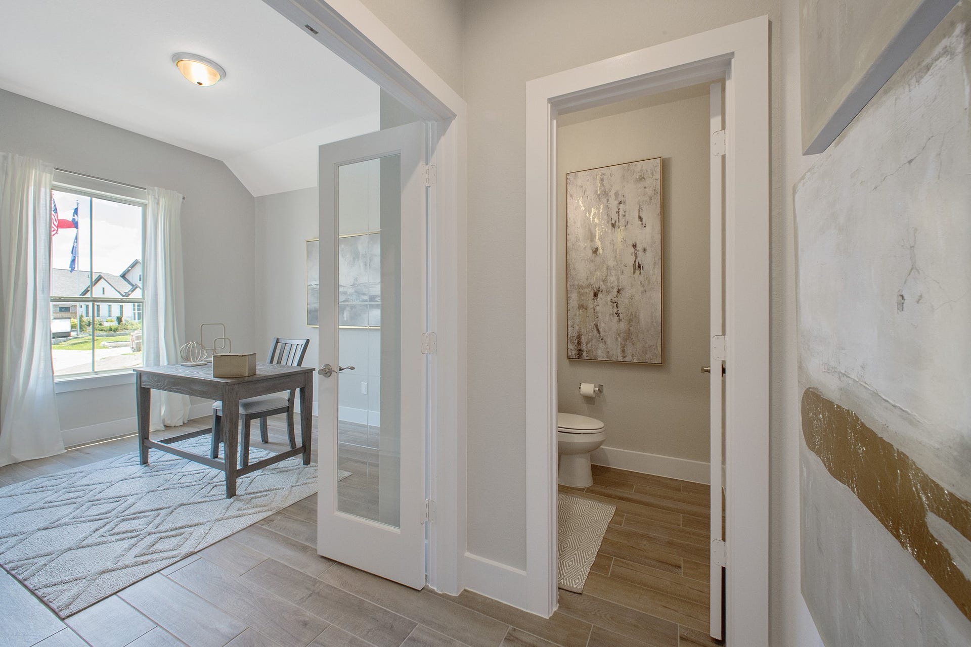 22122 Cortona Creek Lane, Hockley, TX 77447 Experience the perfect blend of sophistication and warmth in this home office, boasting elegant wood-look tile flooring and flooded with natural light from expansive windows and French doors.