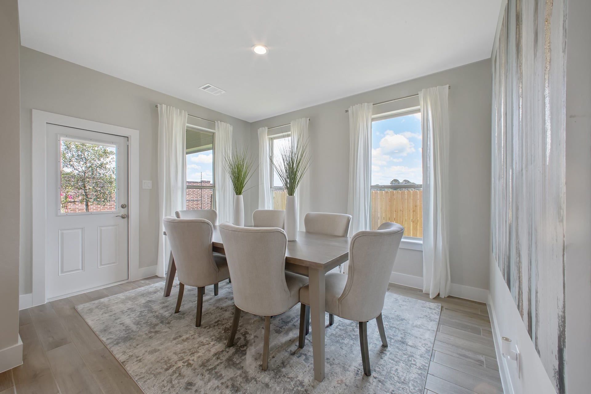 22122 Cortona Creek Lane, Hockley, TX 77447 Create lasting memories with your family and friends at the dining table! This expansive dining room showcases sophisticated flooring, custom paint, and seamlessly connects to the family room and kitchen, providing an open and inviting atmosphere