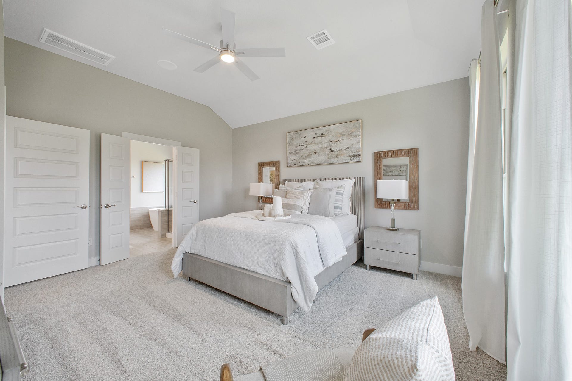22122 Cortona Creek Lane, Hockley, TX 77447 Retreat to the luxurious primary suite, your perfect escape for unwinding after a long day. Located on the first floor, this spacious room features plush carpeting, calming paint tones, high ceilings, and large windows with privacy blinds.