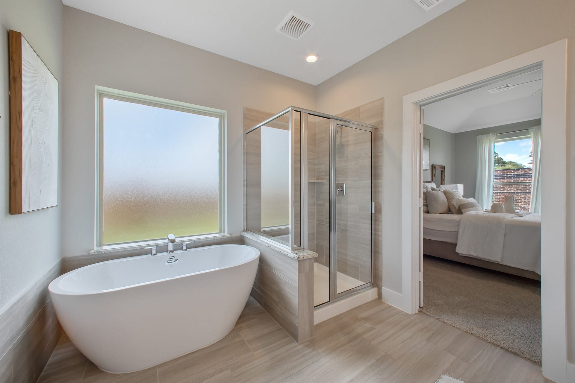 22122 Cortona Creek Lane, Hockley, TX 77447 Indulge in a spa-like retreat within the confines of this primary bathroom. Delight in a spacious walk-in shower enveloped in stylish tile surround, unwind in a separate garden tub adorned with custom detailing.