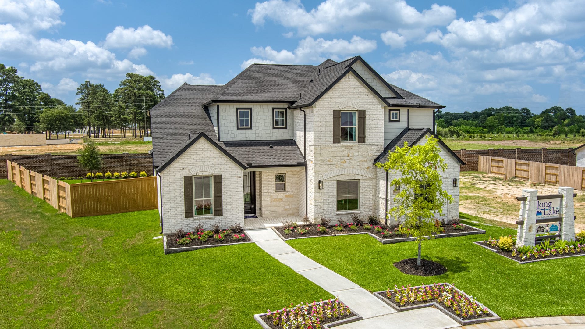 22122 Cortona Creek Lane, Hockley, TX 77447 Meticulously maintained yard and lush landscape, paired with a premium elevation featuring captivating brick accents. Modern coach lights add a touch of contemporary elegance to the exterior.