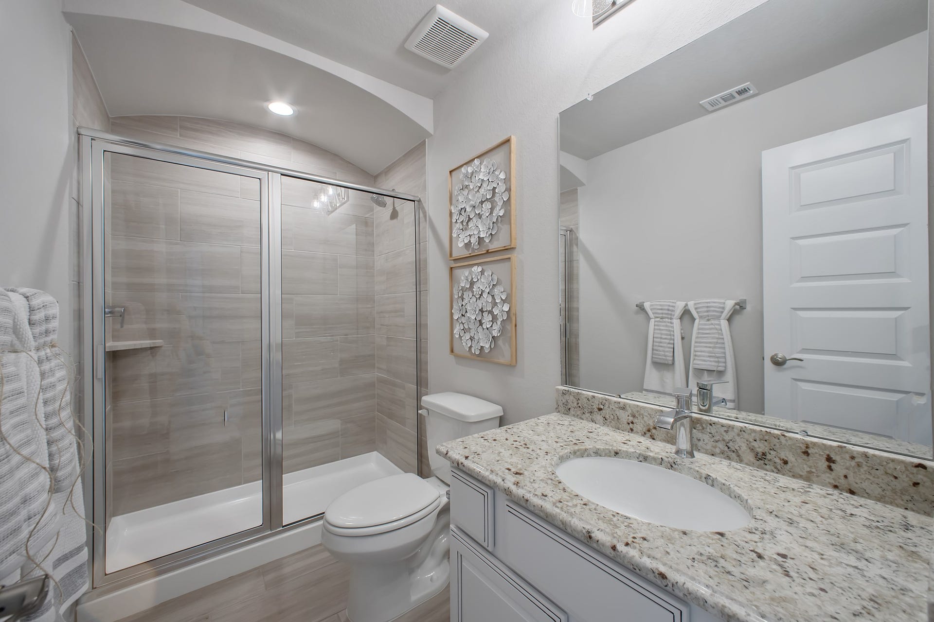 22122 Cortona Creek Lane, Hockley, TX 77447 Secondary bath features tile flooring, walk-in shower with tile surround, light stained wood cabinets, beautiful light countertop.