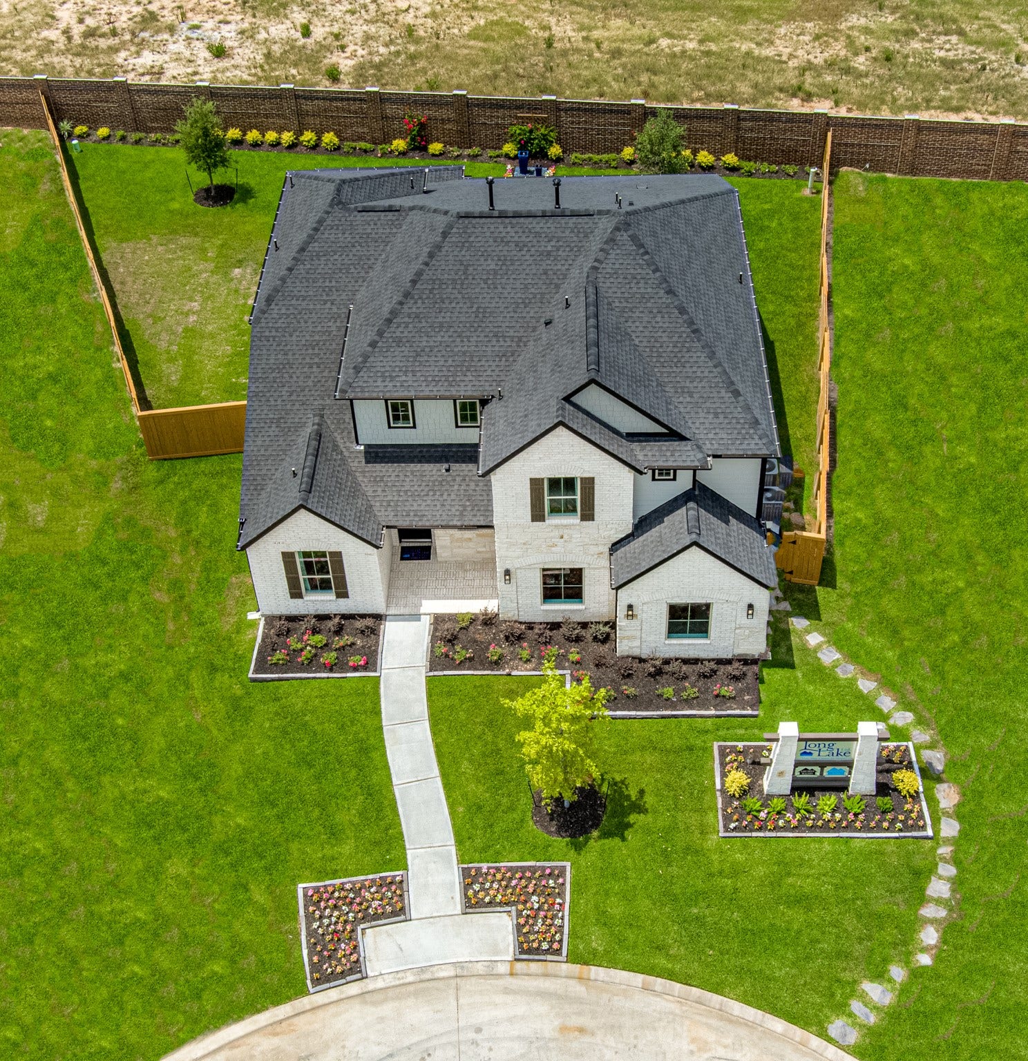 22122 Cortona Creek Lane, Hockley, TX 77447 An aerial view of a spacious subdivision lot, highlighting a well-maintained yard and a fully fenced perimeter, offering both privacy and expansive outdoor space.