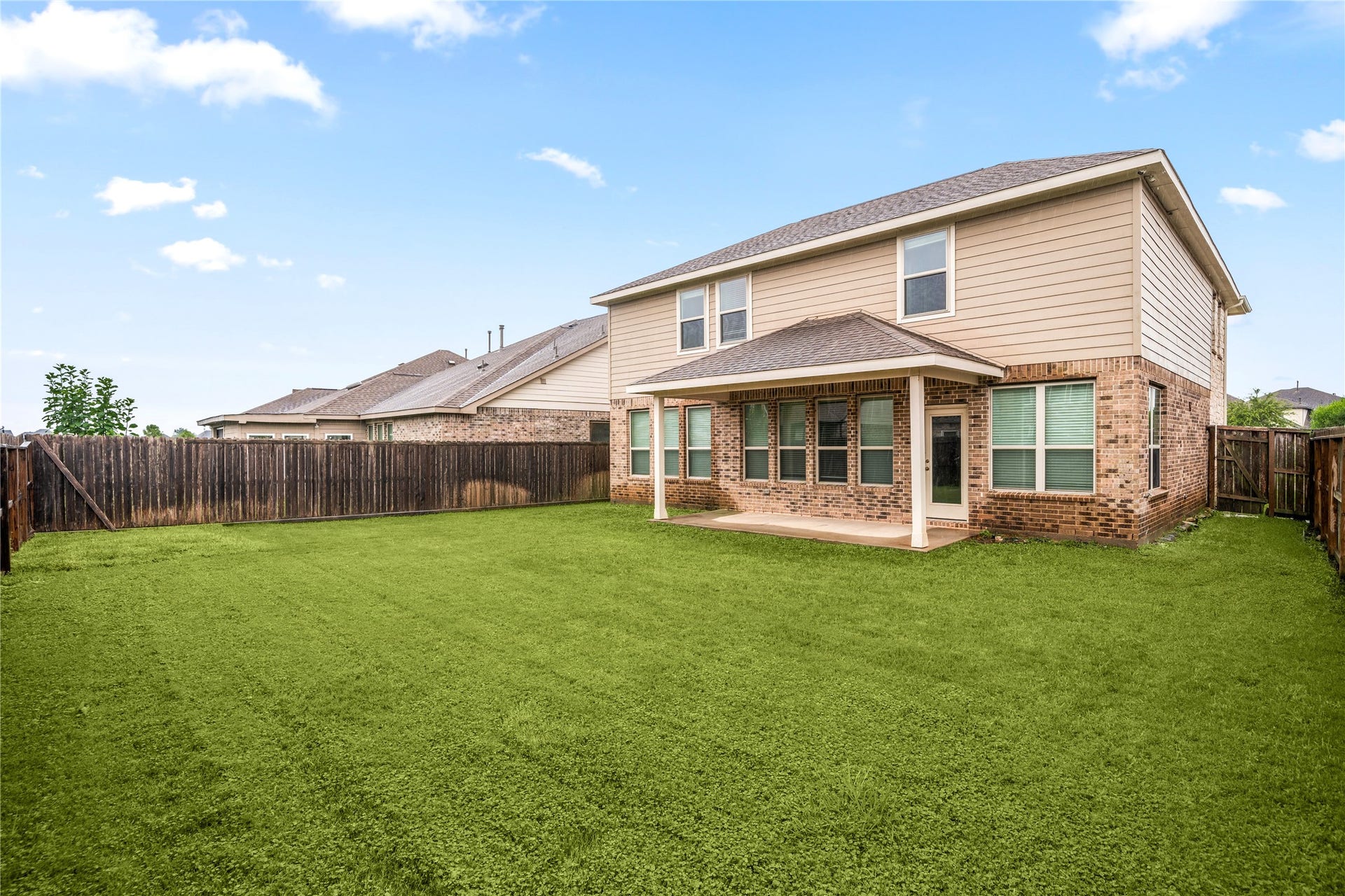 2418 Green Kale Drive, Richmond, TX 77406 This expansive backyard is a true highlight, offering a generous covered patio, lush green lawn, and full privacy fencing, the perfect blank canvas for a pool, play area, garden, or outdoor entertaining!