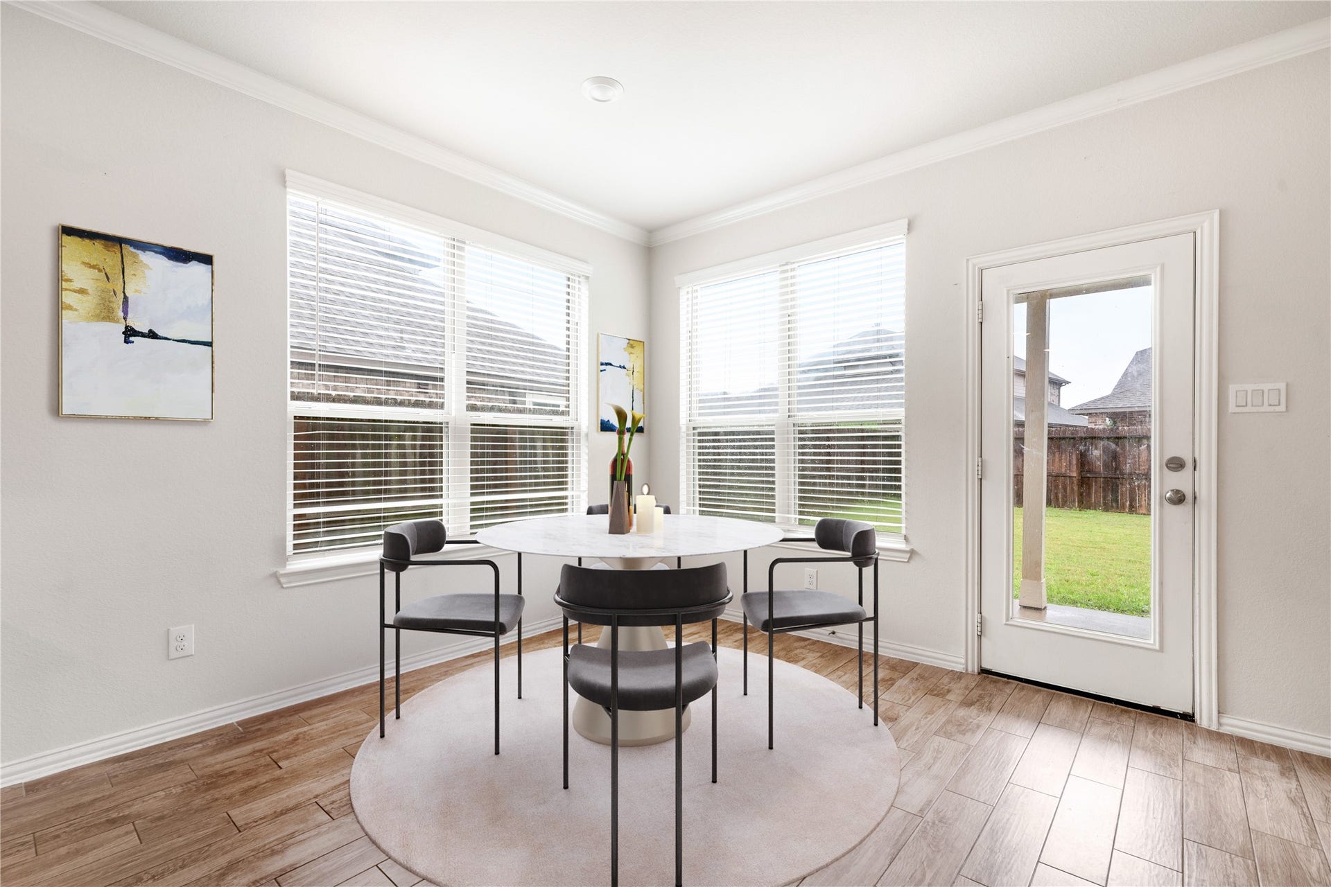 2418 Green Kale Drive, Richmond, TX 77406 The sunny breakfast nook is the perfect spot to start your day, featuring crown molding, wood-look tile flooring, and large windows plus an exterior door with backyard views and access! *Virtually Staged