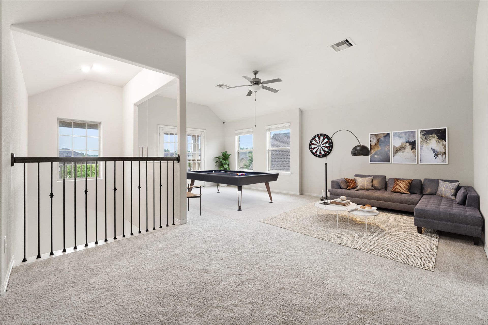 2418 Green Kale Drive, Richmond, TX 77406 Versatile and full of natural light, the spacious game room offers vaulted ceilings, a ceiling fan, carpeting throughout, and wrought iron railings overlooking the staircase, the perfect spot to relax, play, or entertain! *Virtually Staged