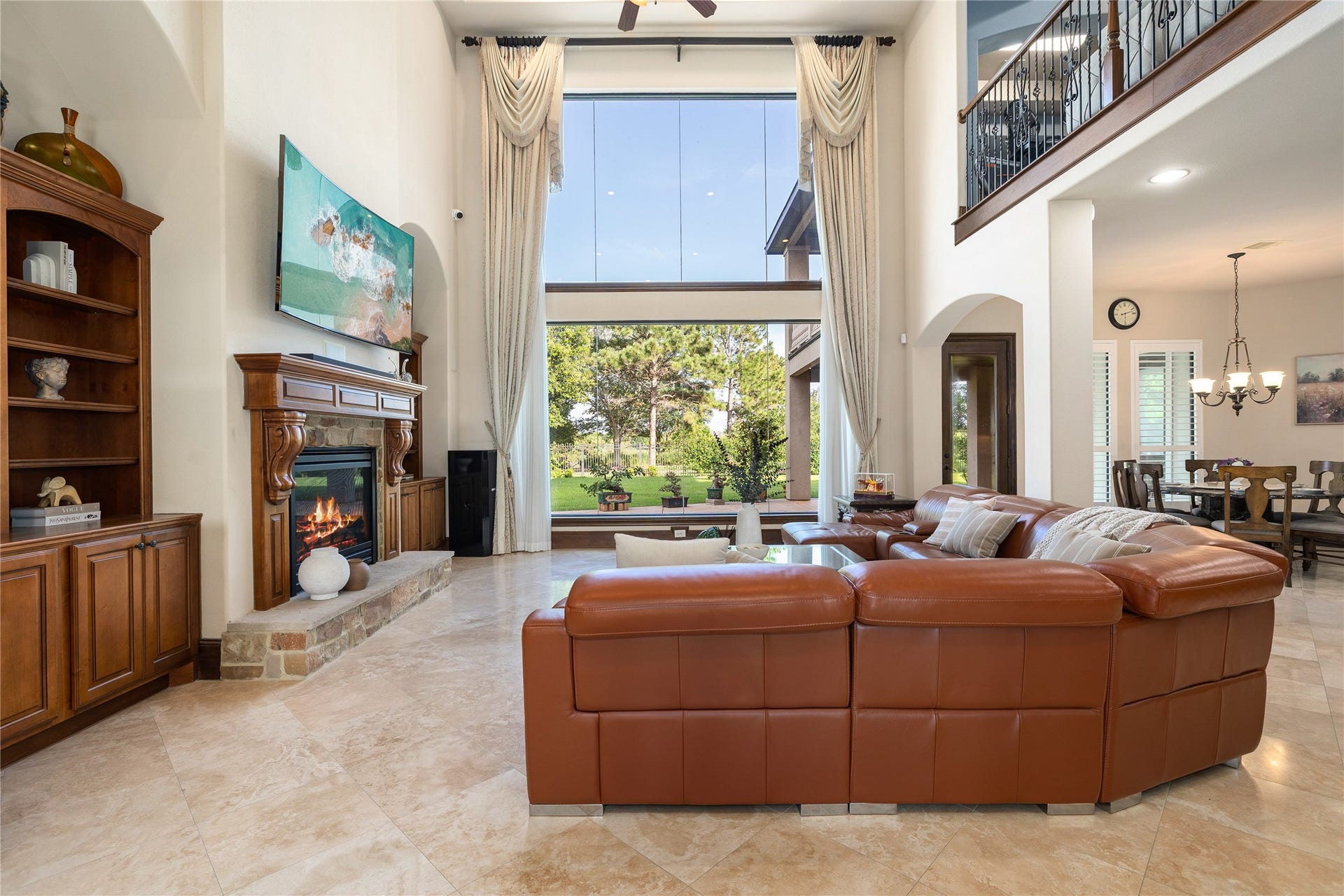 27711 Charter Lake Lane, Katy, TX 77494 Expansive windows and dramatic ceilings fill the home with natural light while capturing breathtaking lake views
