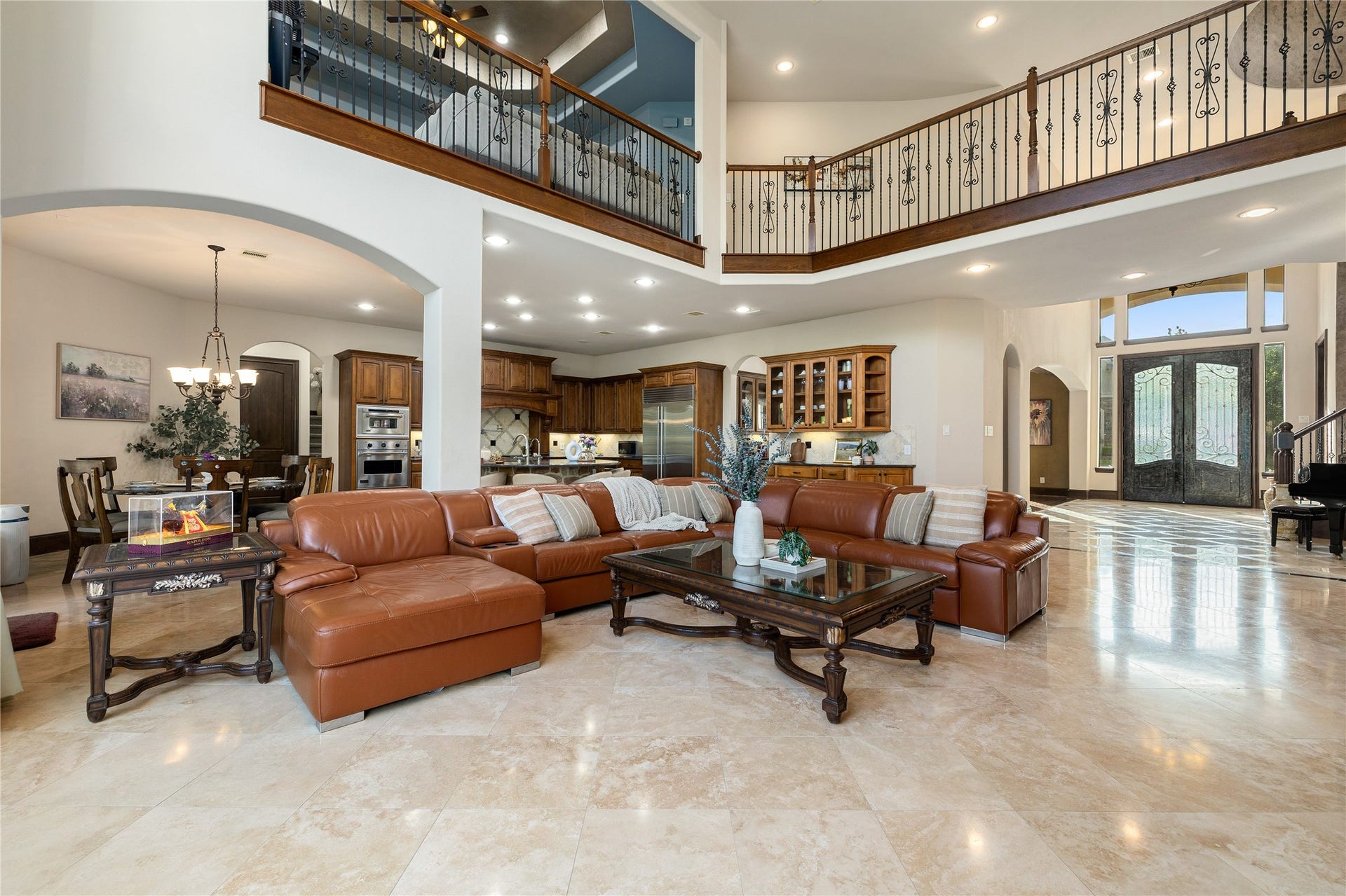 27711 Charter Lake Lane, Katy, TX 77494 Spacious Living room with custom built-ins, statement fireplace, soaring ceilings, and breathtaking waterfront views.
