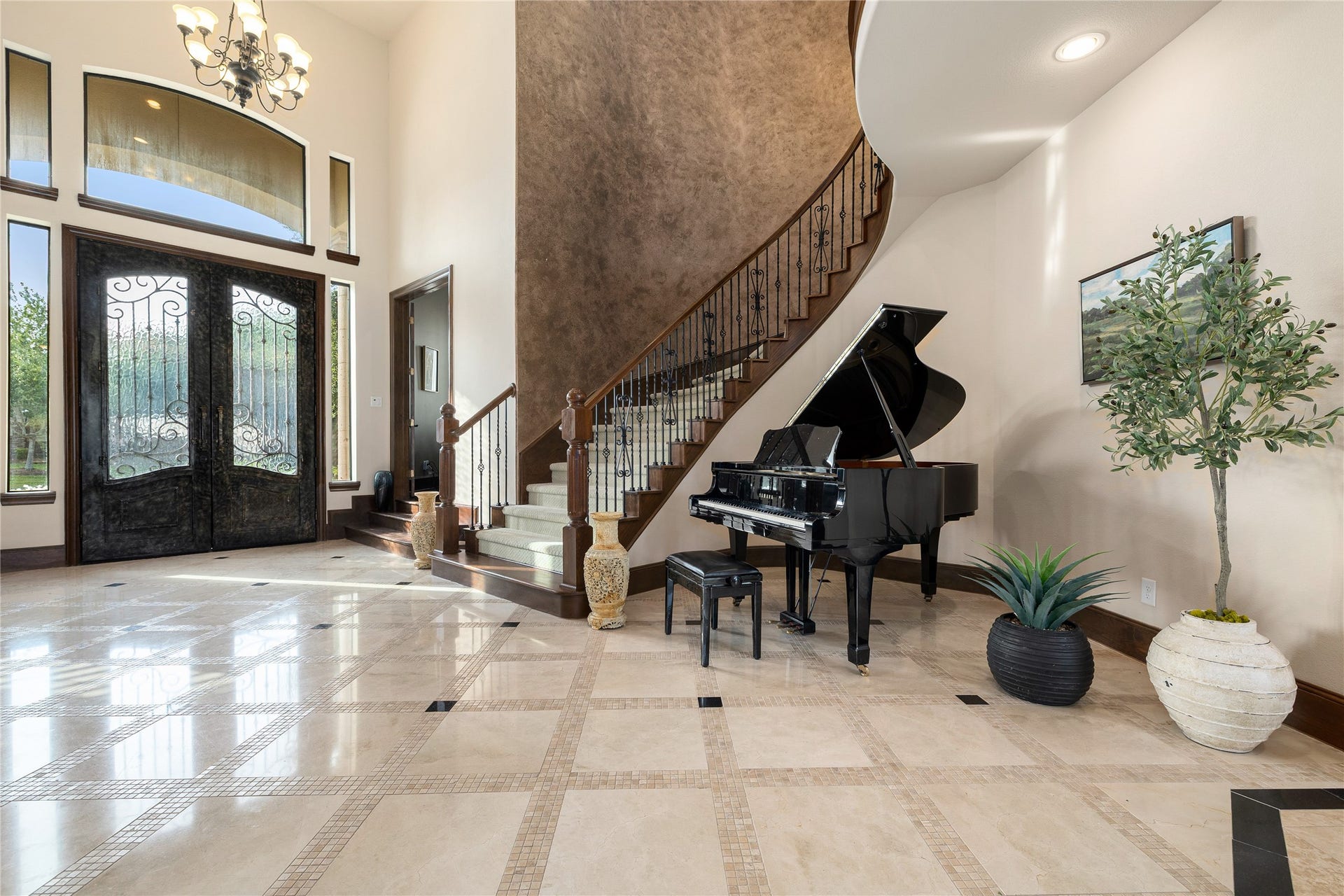 27711 Charter Lake Lane, Katy, TX 77494 Spectacular curved staircase accented by custom iron balusters and architectural detailing, serving as the centerpiece of the home.