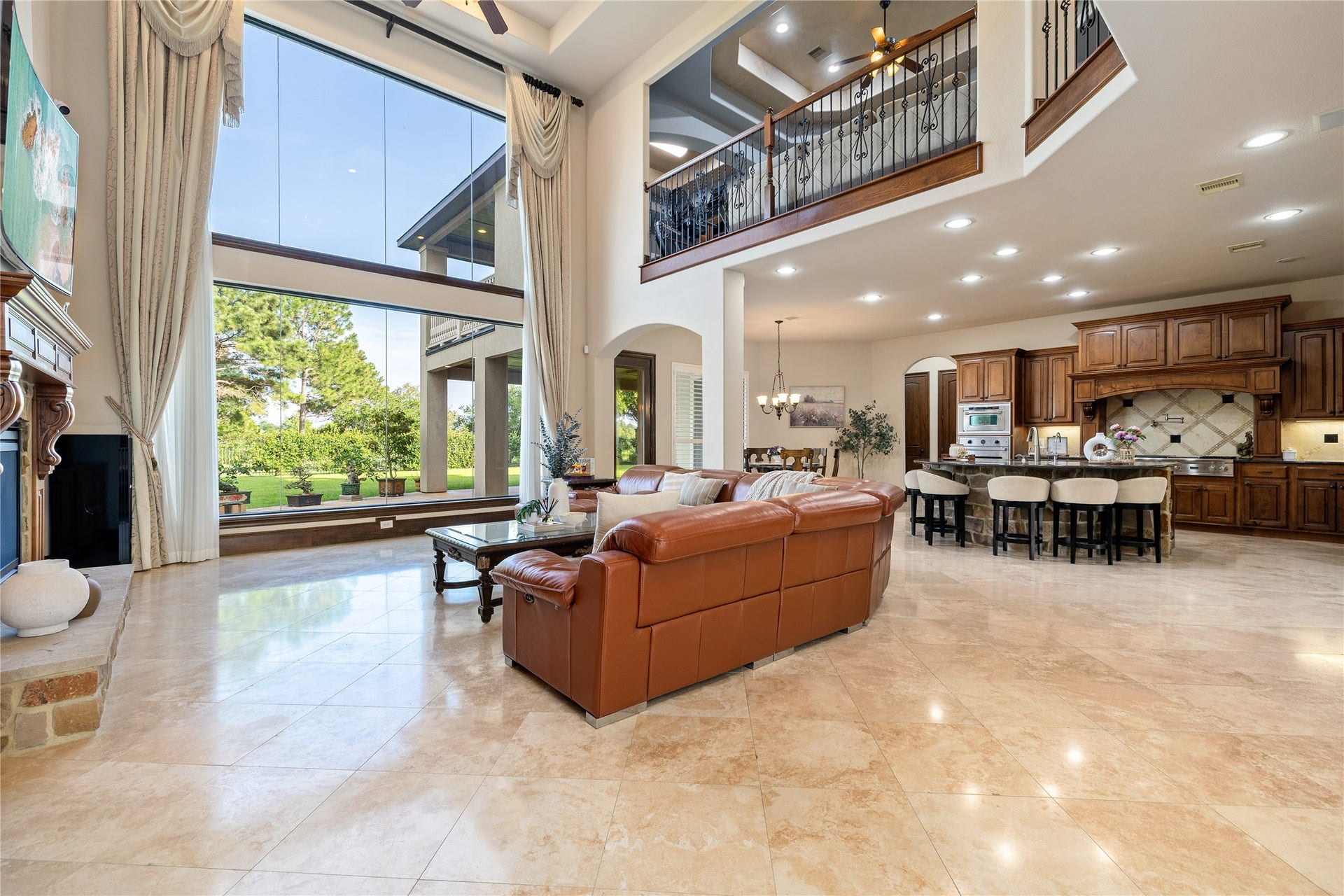 27711 Charter Lake Lane, Katy, TX 77494 Walls of windows flood the home with natural light while capturing panoramic lake views.