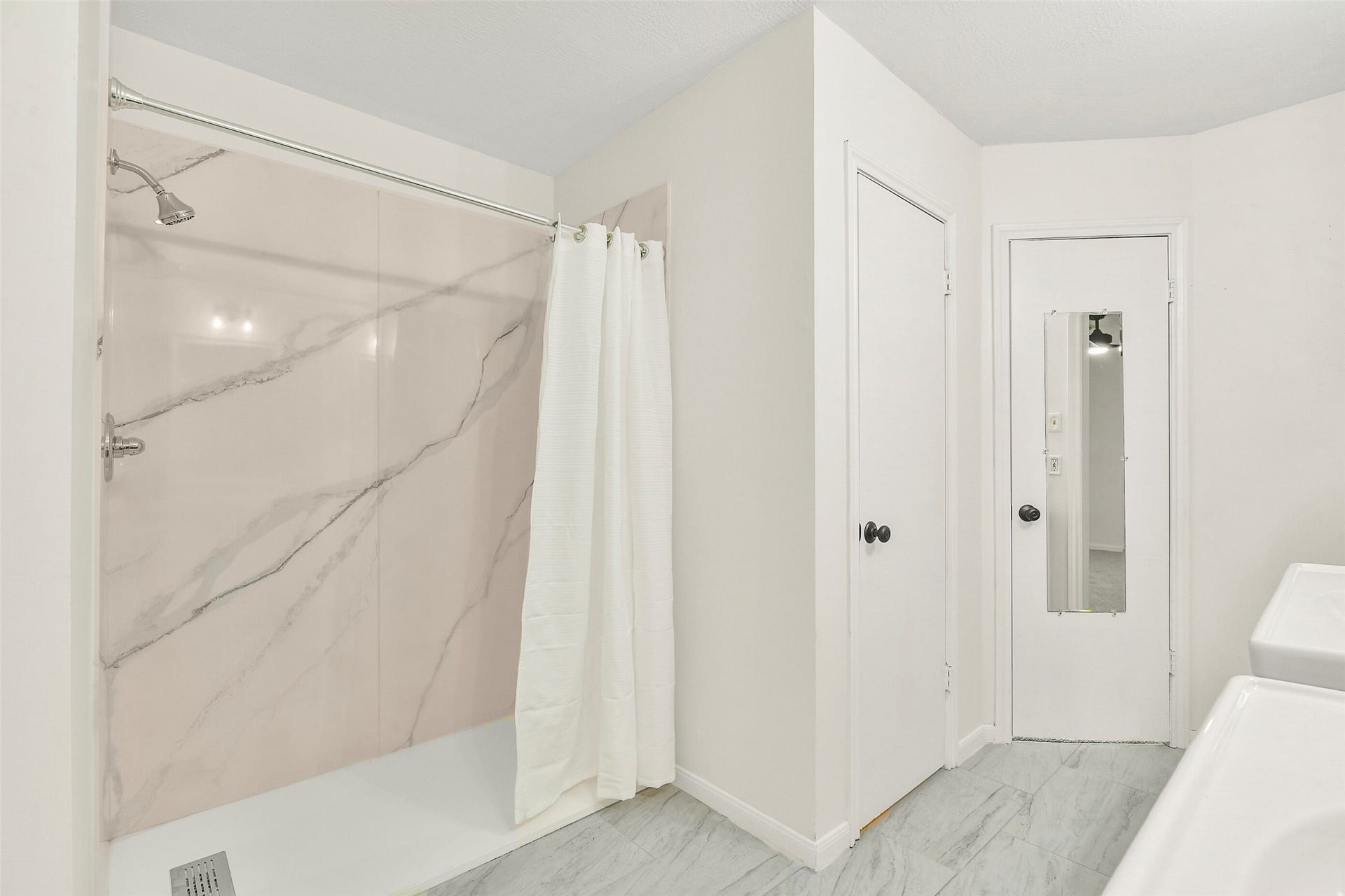 The primary ensuite has been updated with a quartz shower surround...  easy maintenance and convenience!
