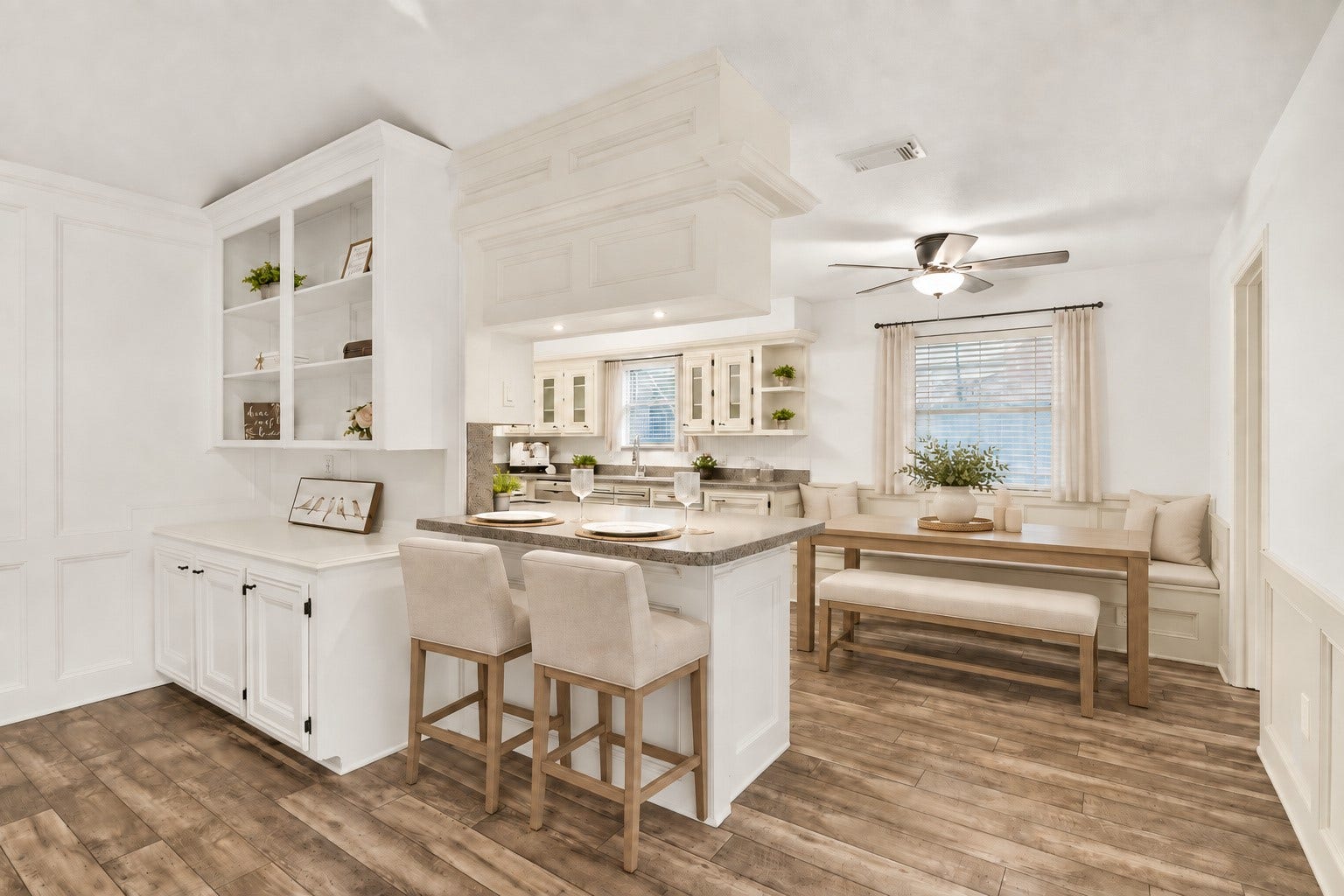 The kitchen offers a breakfast area as well as an additional barstool counter. There is plenty of space in this kitchen! Virtually staged.