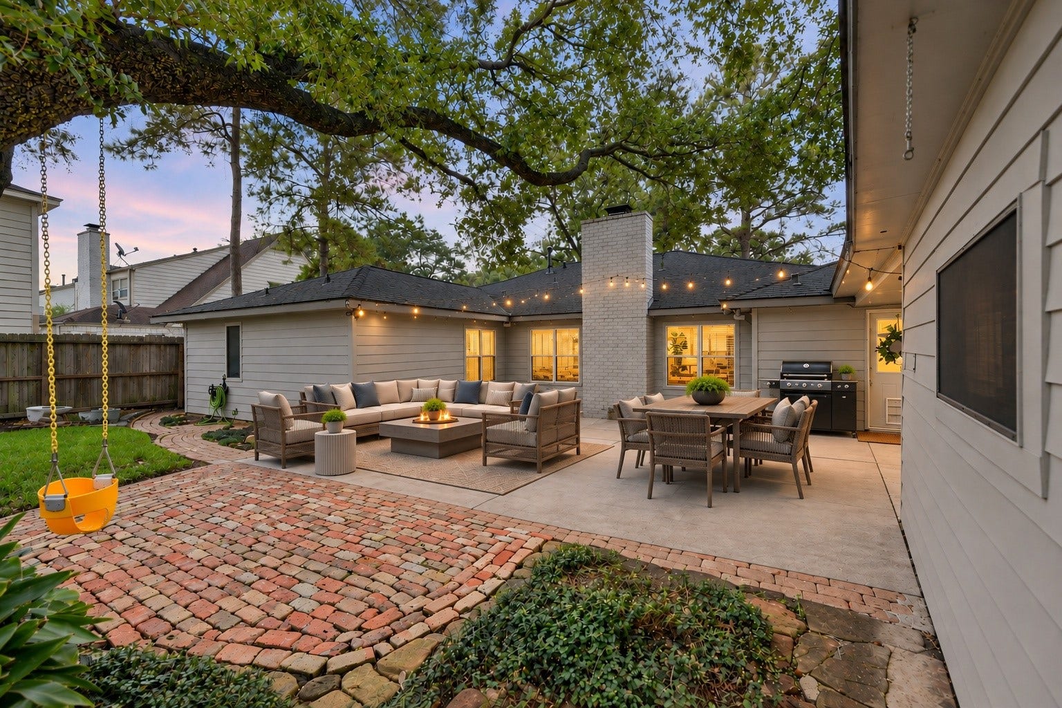 You'll absolutely love this relaxing picturesque backyard! Features string lights for those wonderful evening family meals you'll have here! There's even a child's swing... and look at the beautiful brick pavers... the home and the garage have been updated wtih hardi plank siding as well!  Virtually staged...
