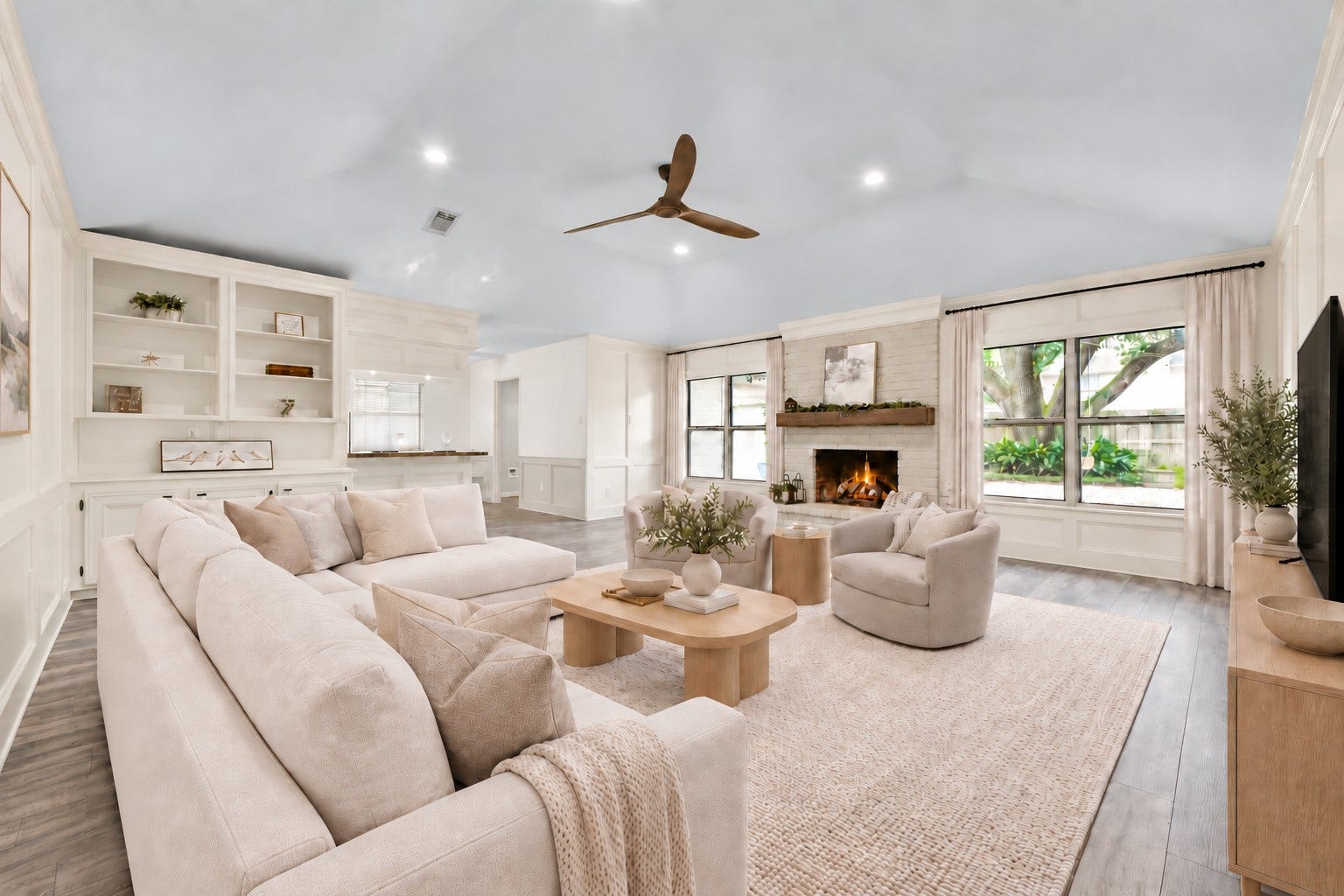 Another view of the family room... enjoy a gas log fireplace along with an amazing view of your picturesque backyard through the 2 large windows. You'll love the built in shelves/cabinet! Virtually Staged.