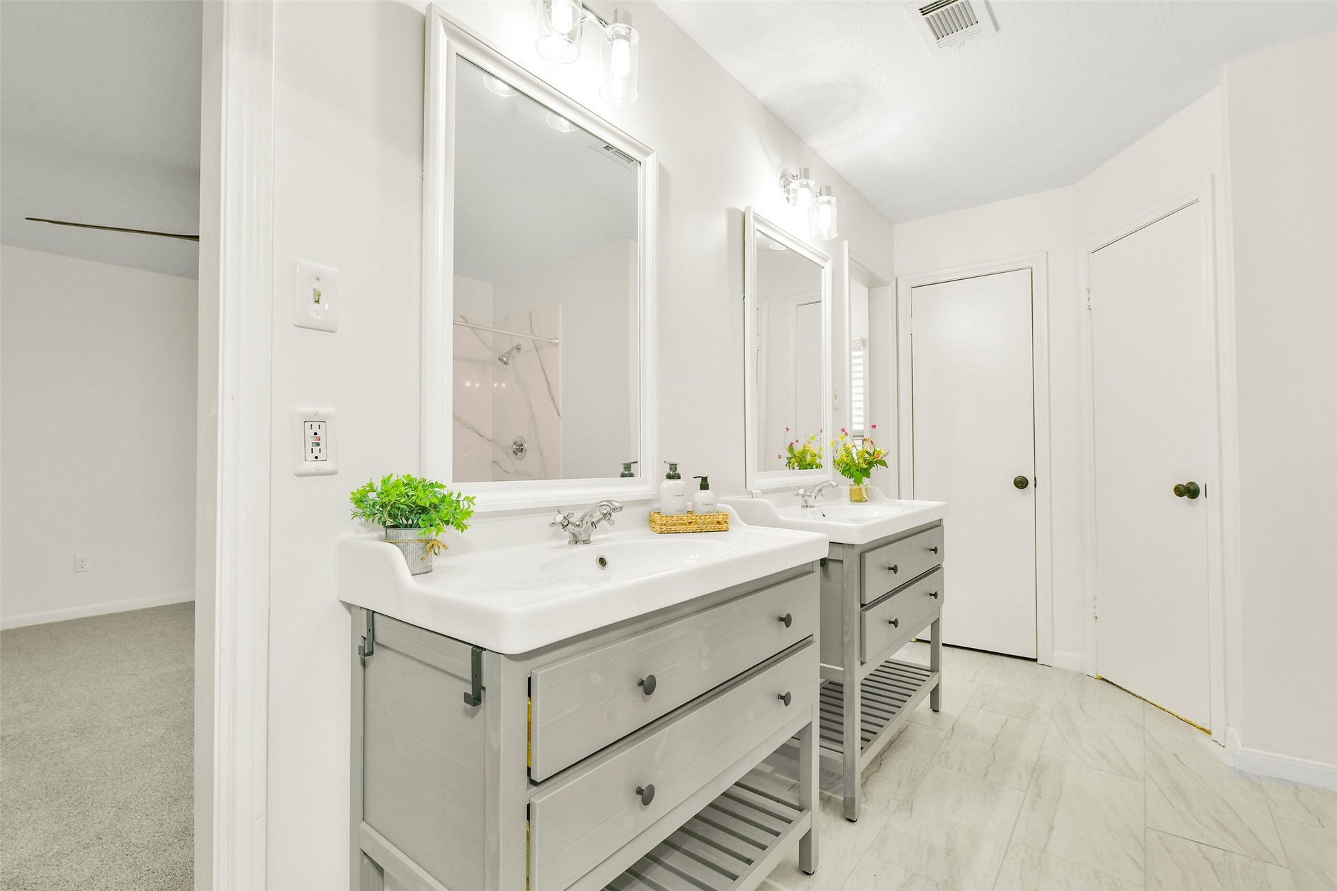 Welcome to your primary bedroom ensuite.... updated double vanities are a plus! Flooring and fixtures have all been updated as well!