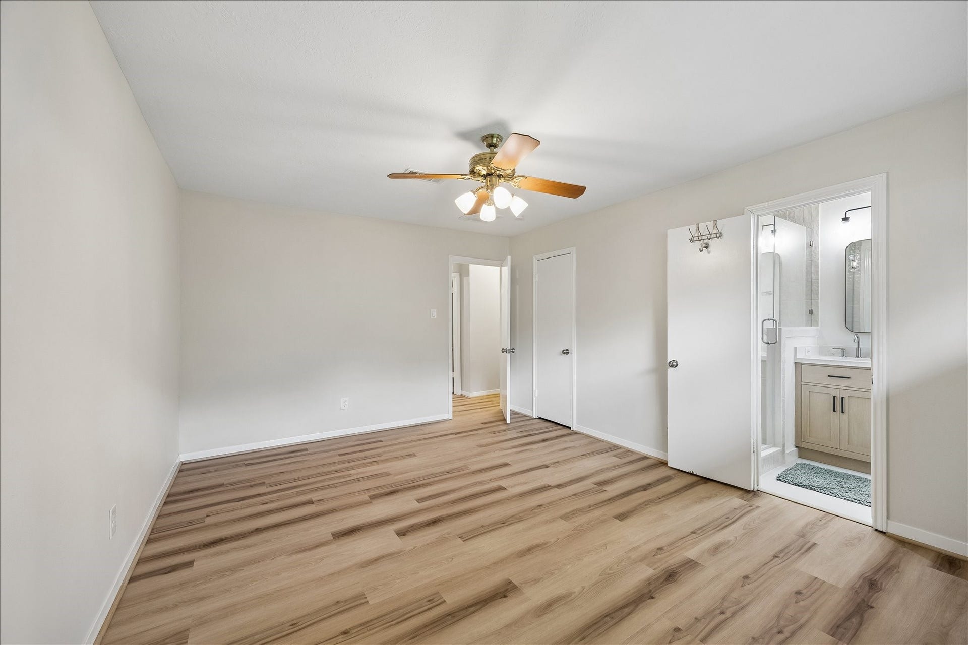 Primary Bedroom- and a peak into the recently remodeled primary bath!
