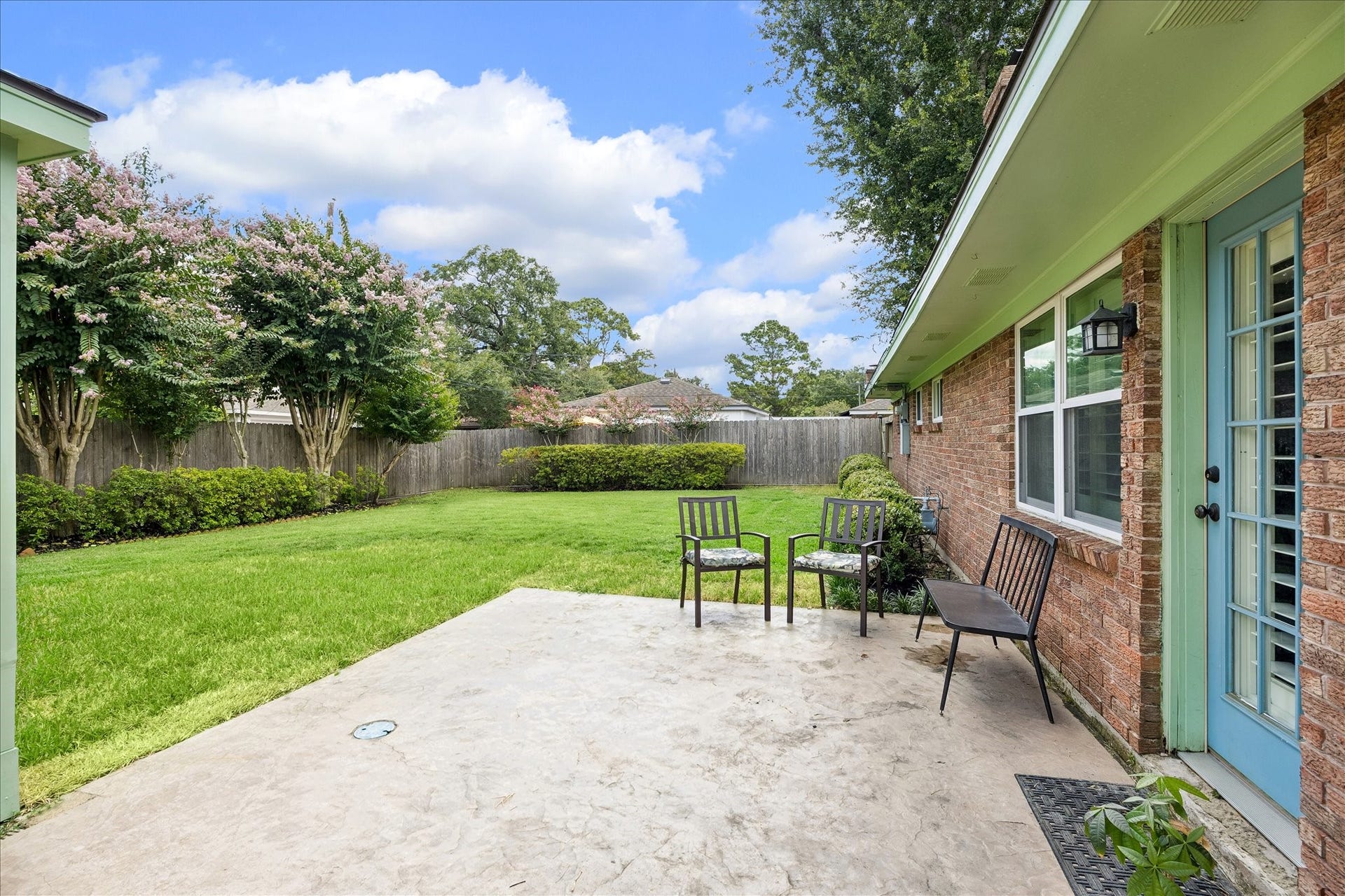 Backyard has a nice size patio and green area.