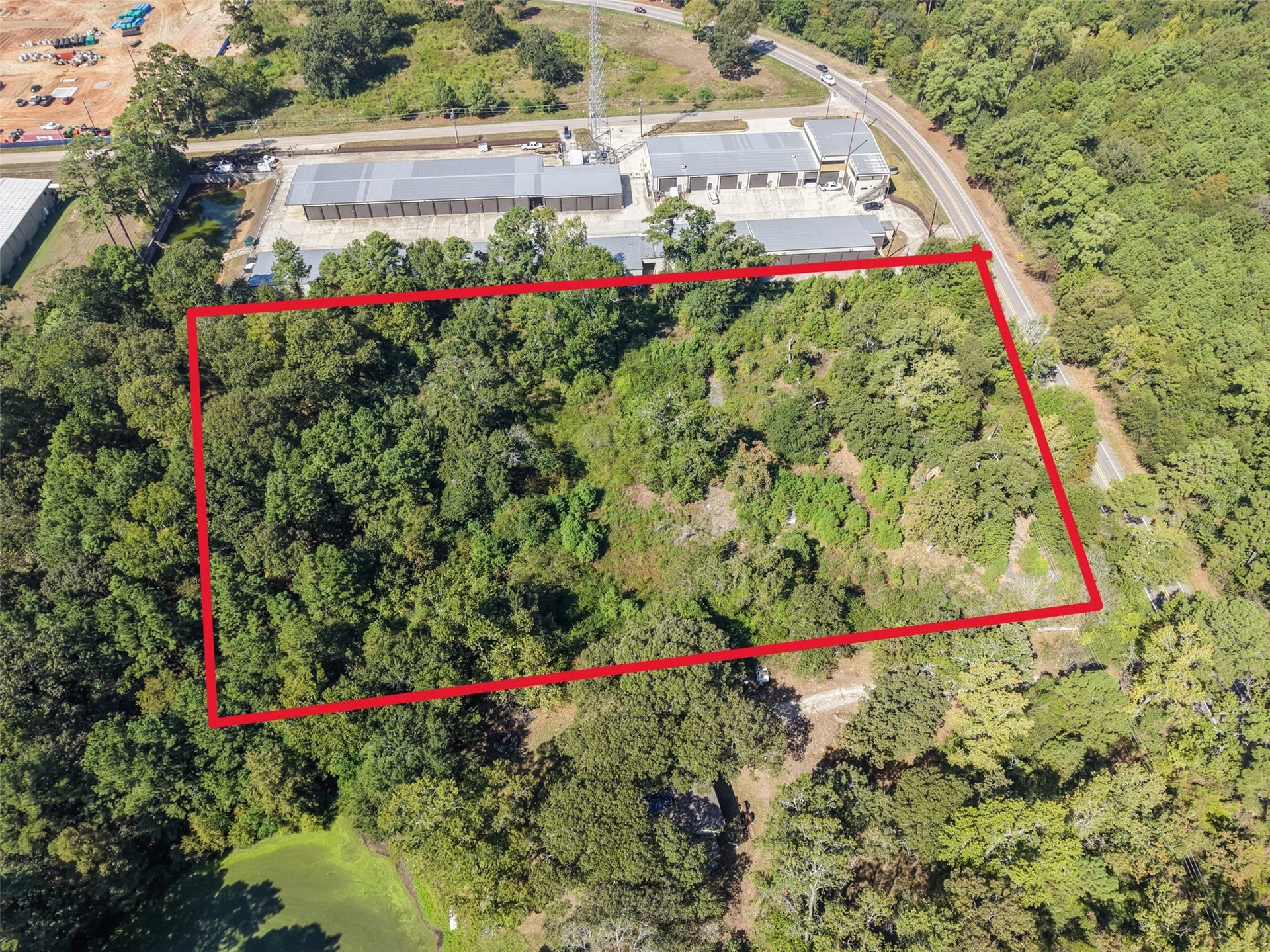 18841 W Fm 1097 Road, Montgomery, TX 77356 Aerial view highlighting the wooded property boundaries and road frontage. This tract offers an attractive setting with convenient access near Lake Conroe.