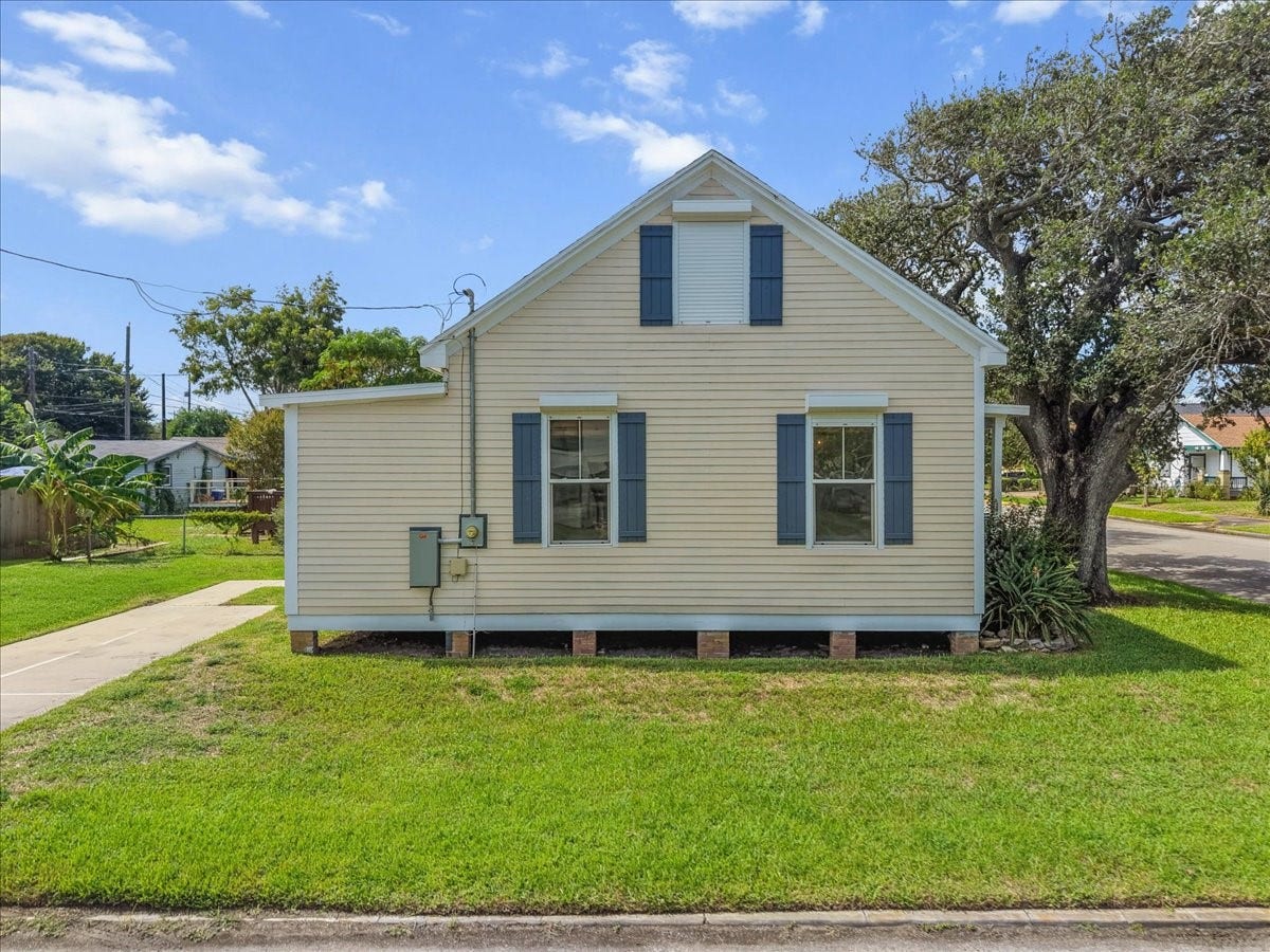4201 Avenue R, Galveston, TX 77550 Side exterior with multiple windows and simple coastal styling.