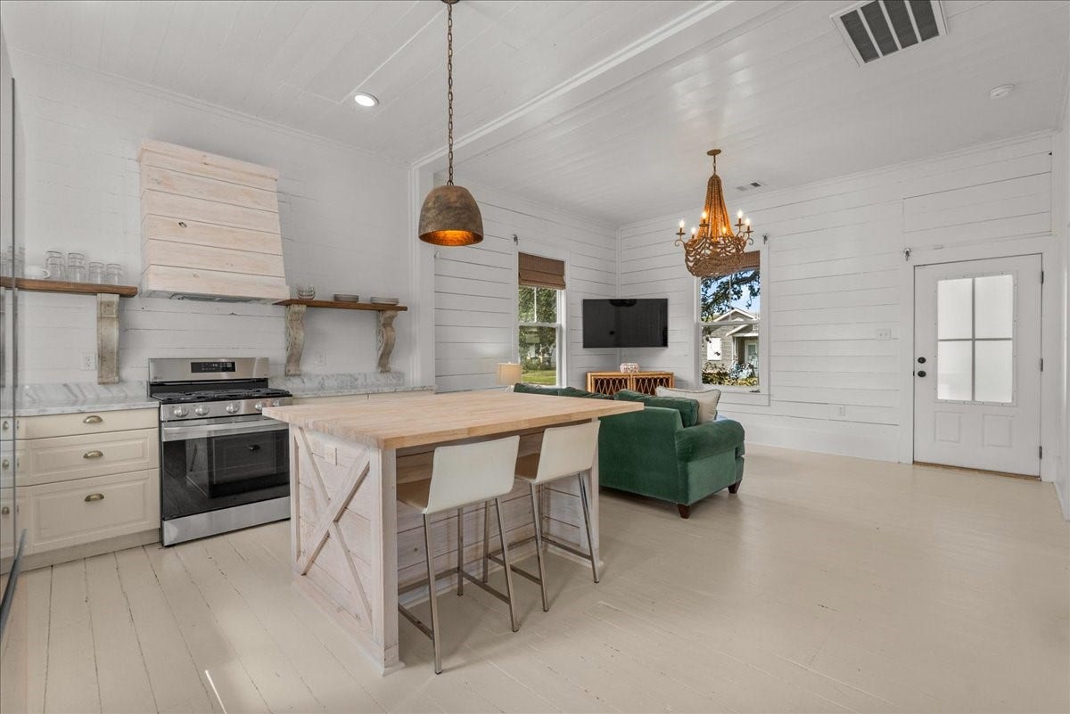4201 Avenue R, Galveston, TX 77550 Light-filled kitchen with updated cabinetry and island seating.