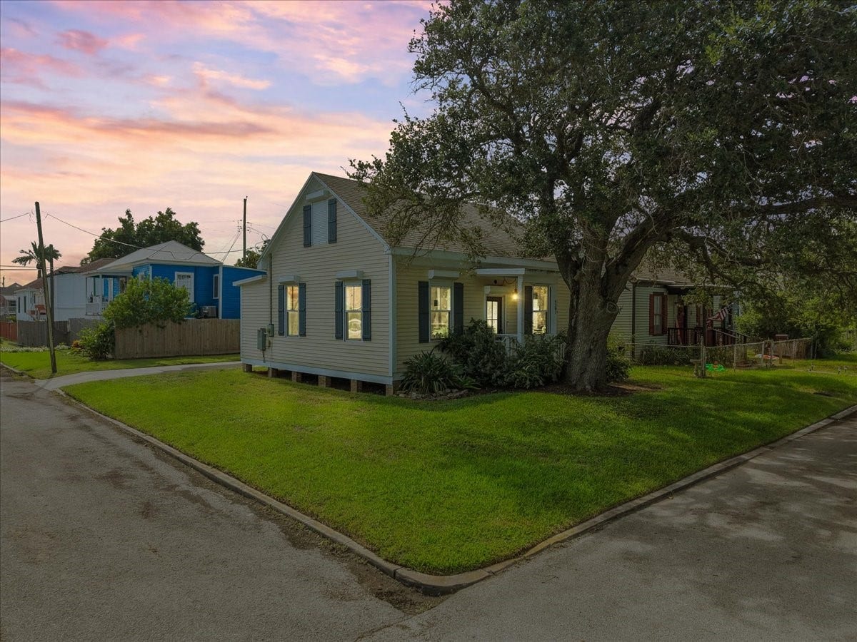 4201 Avenue R, Galveston, TX 77550 Evening exterior view with mature trees framing the property.