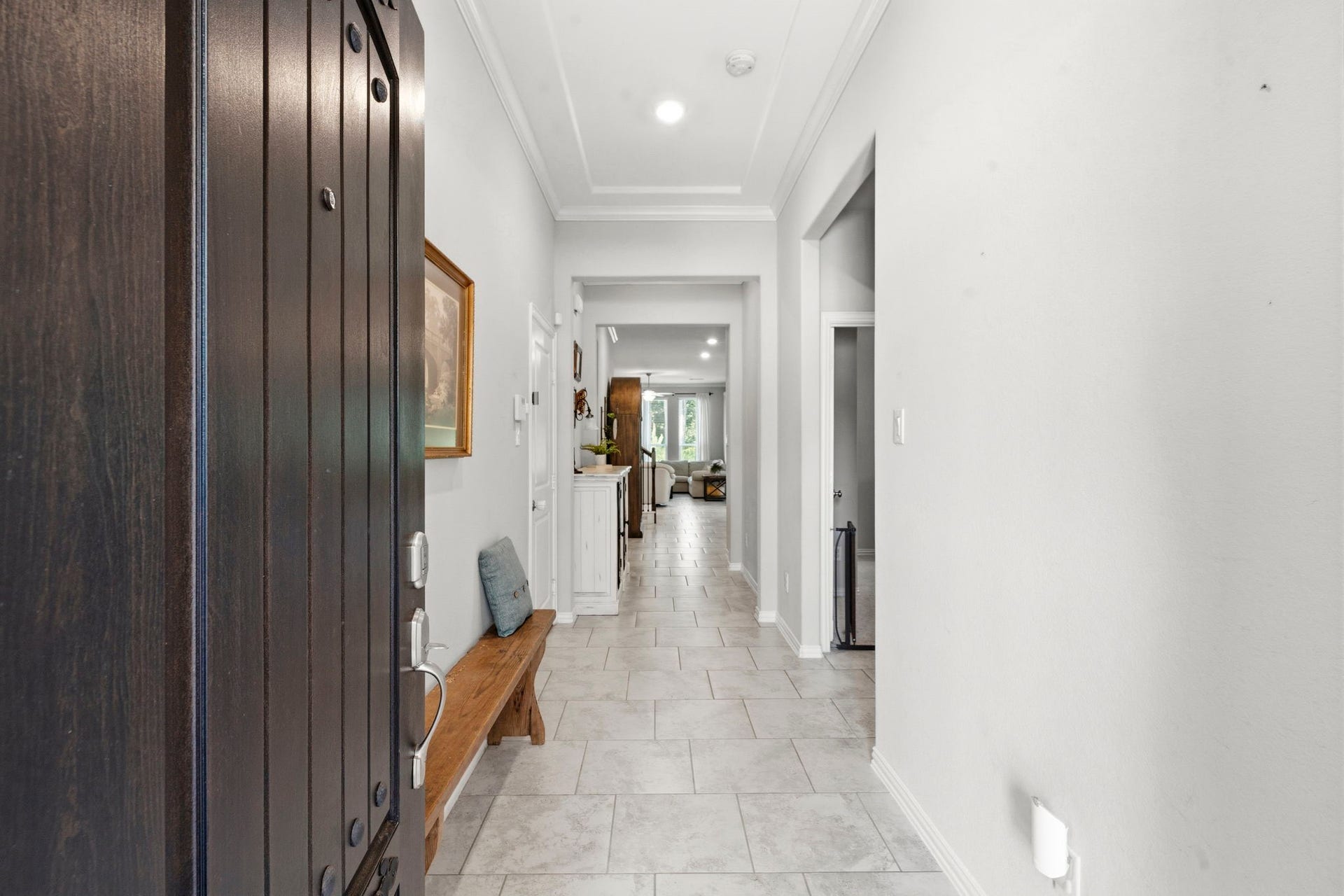2143 Moss Creek Lane, Conroe, TX 77304 Step through the front door into a spacious foyer with elevated ceilings, creating a bright and welcoming first impression.