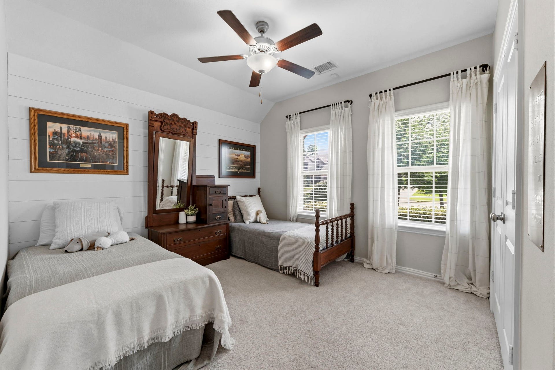 2143 Moss Creek Lane, Conroe, TX 77304 Bedroom #3 features a custom shiplap accent wall, oversized windows that fill the room with natural light, a spacious closet, and convenient access to a full bathroom.