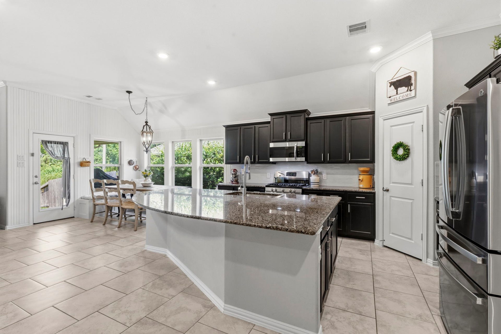 2143 Moss Creek Lane, Conroe, TX 77304 View from the open, airy kitchen overlooking the dining room and covered patio.