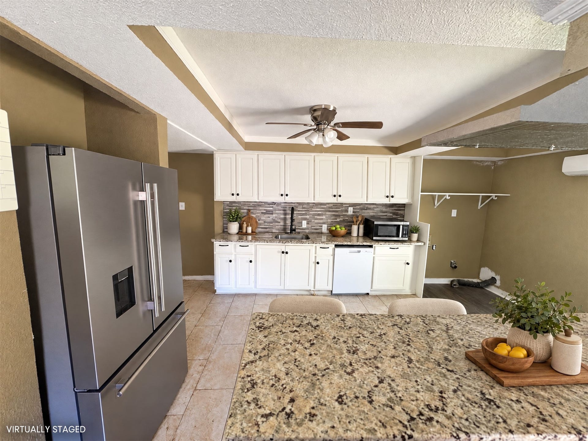 113 N Pecan Drive, Texas City, TX 77591 Virtually staged: simple countertop accents and two stools show a possible kitchen setup.