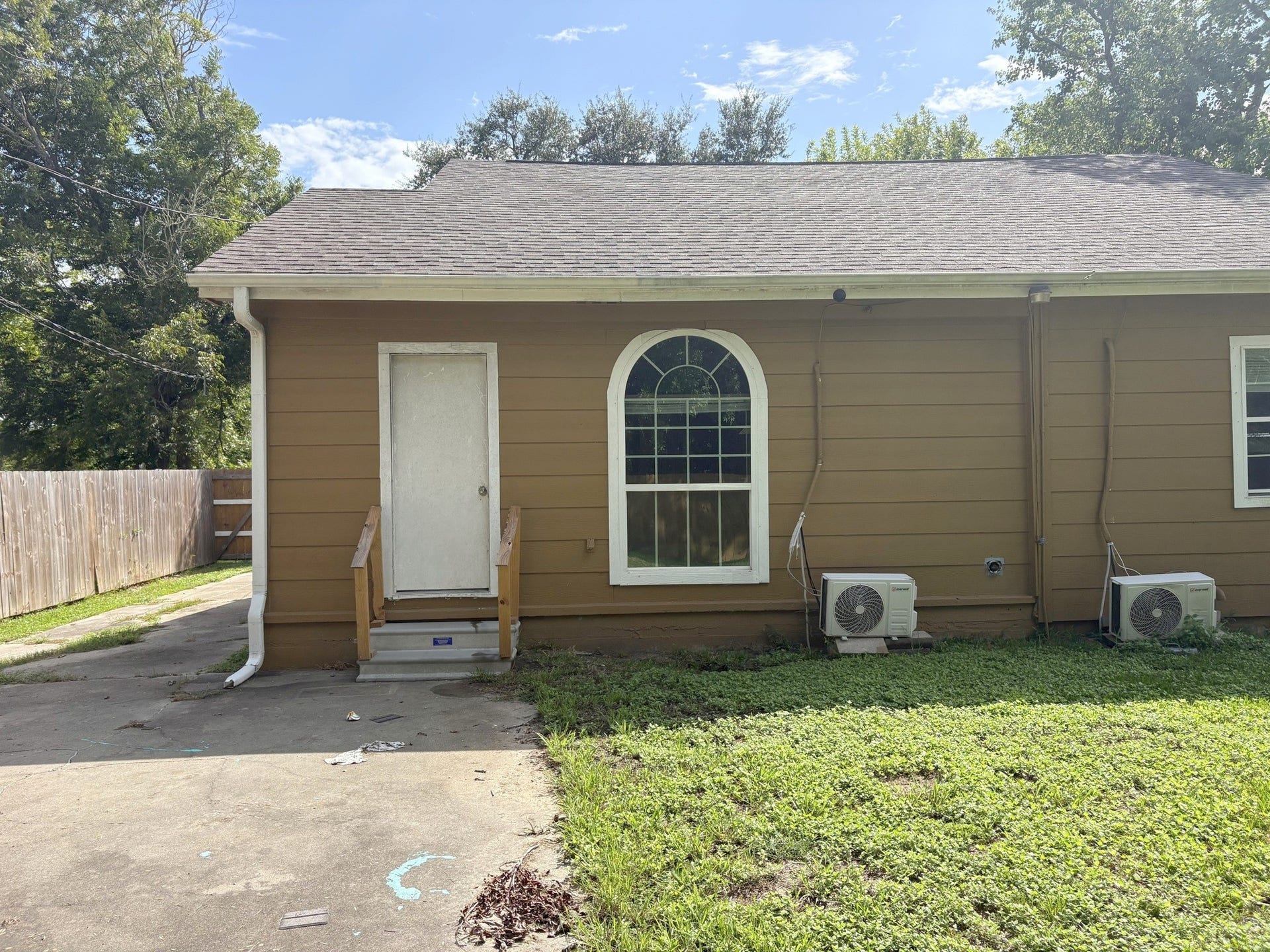 113 N Pecan Drive, Texas City, TX 77591 Rear exterior with an arched window, entry steps, and a view of the existing siding.