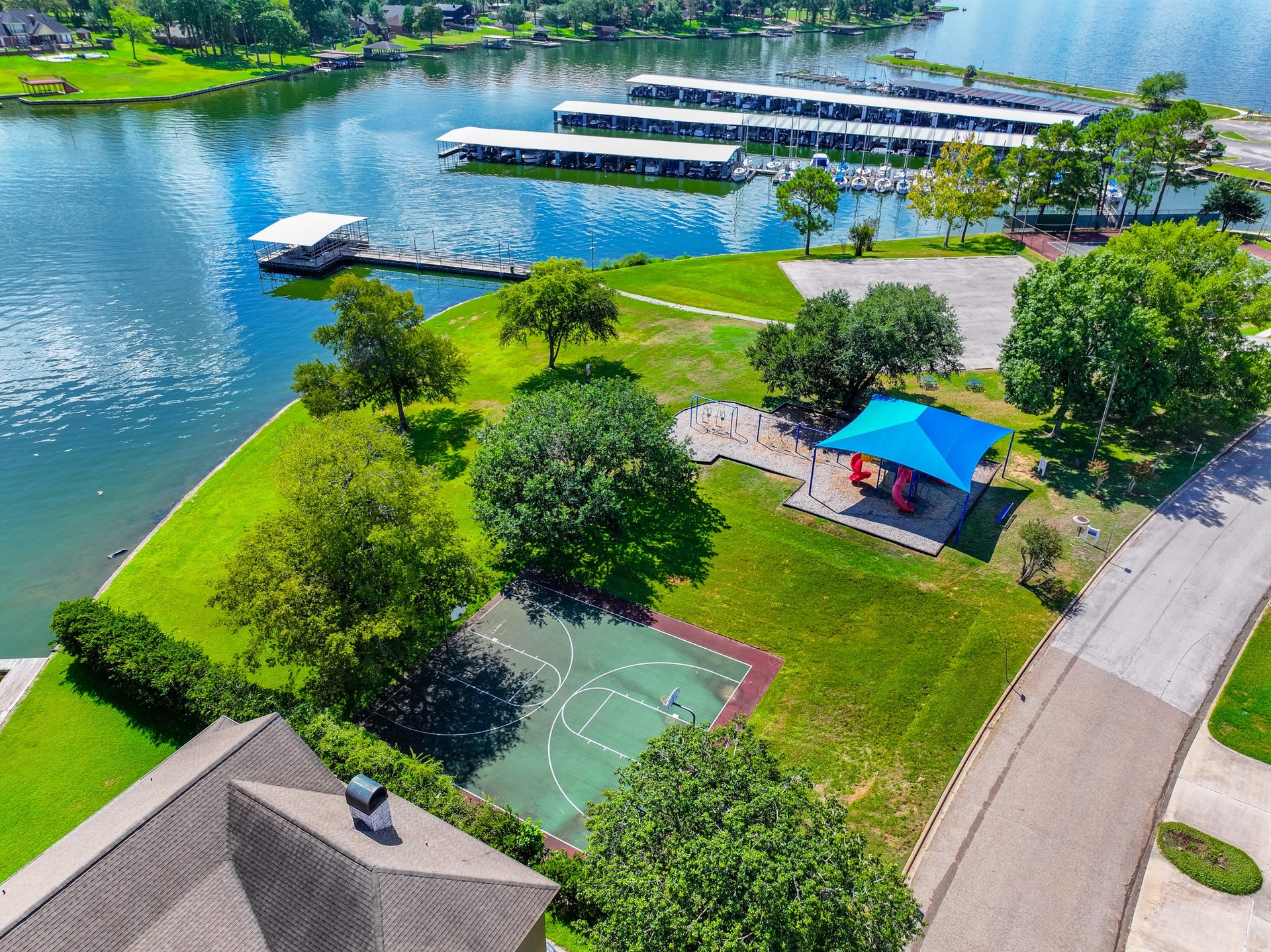 7083 Gentle Breeze Drive, Willis, TX 77318 Basketball court and tennis court with water views!