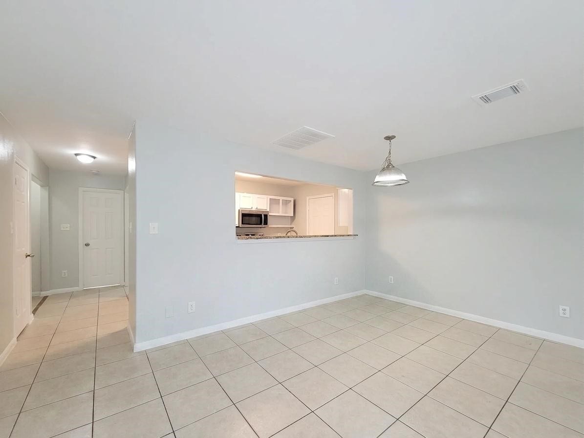 3005 La Estancia Lane, Houston, TX 77093 Bright, open living space with tiled floors and a modern kitchen pass-through, perfect for easy entertaining.