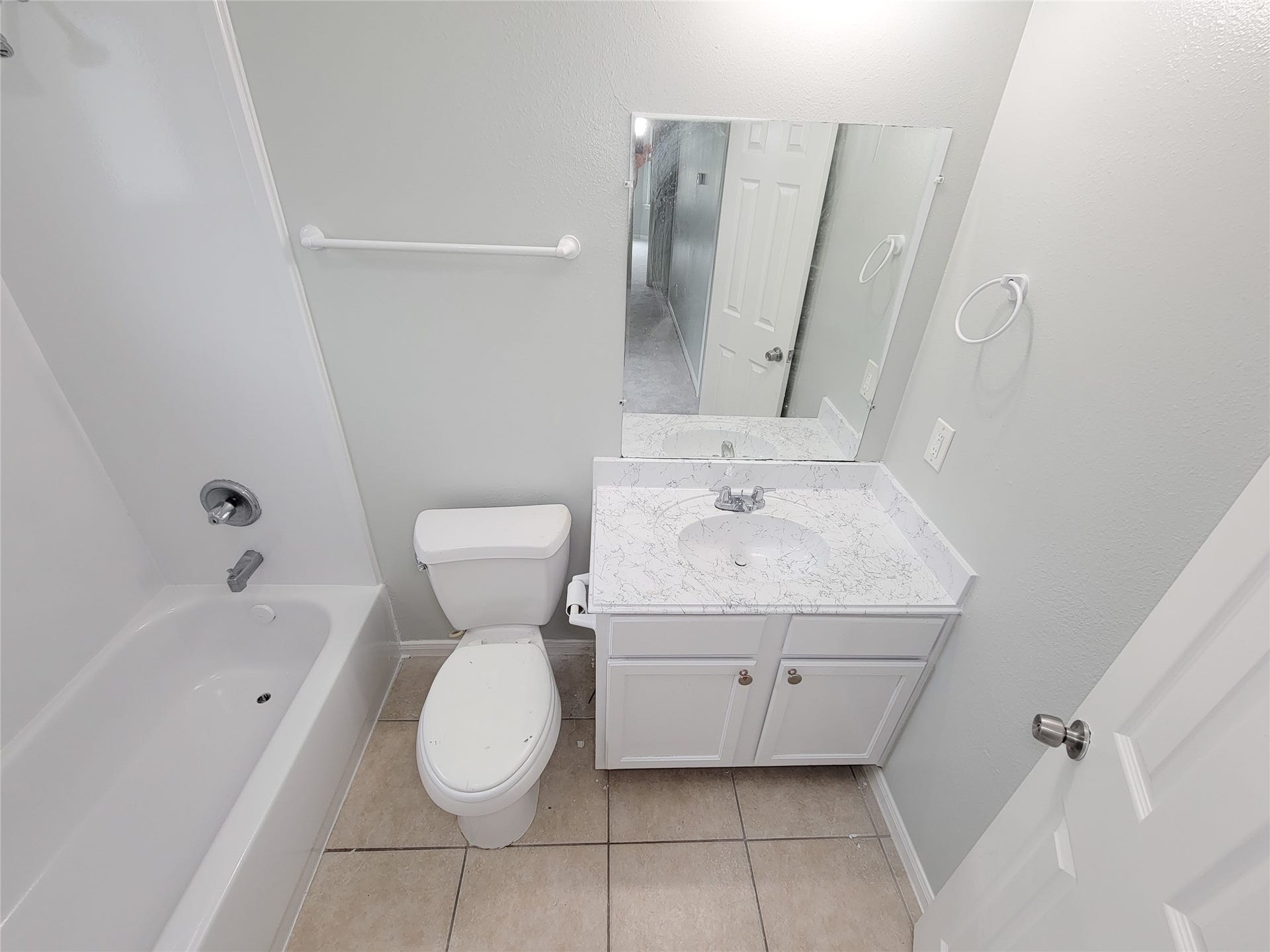 3005 La Estancia Lane, Houston, TX 77093 Bright and clean bathroom featuring a modern vanity with marble-style countertop, large mirror, and a full bathtub with shower.