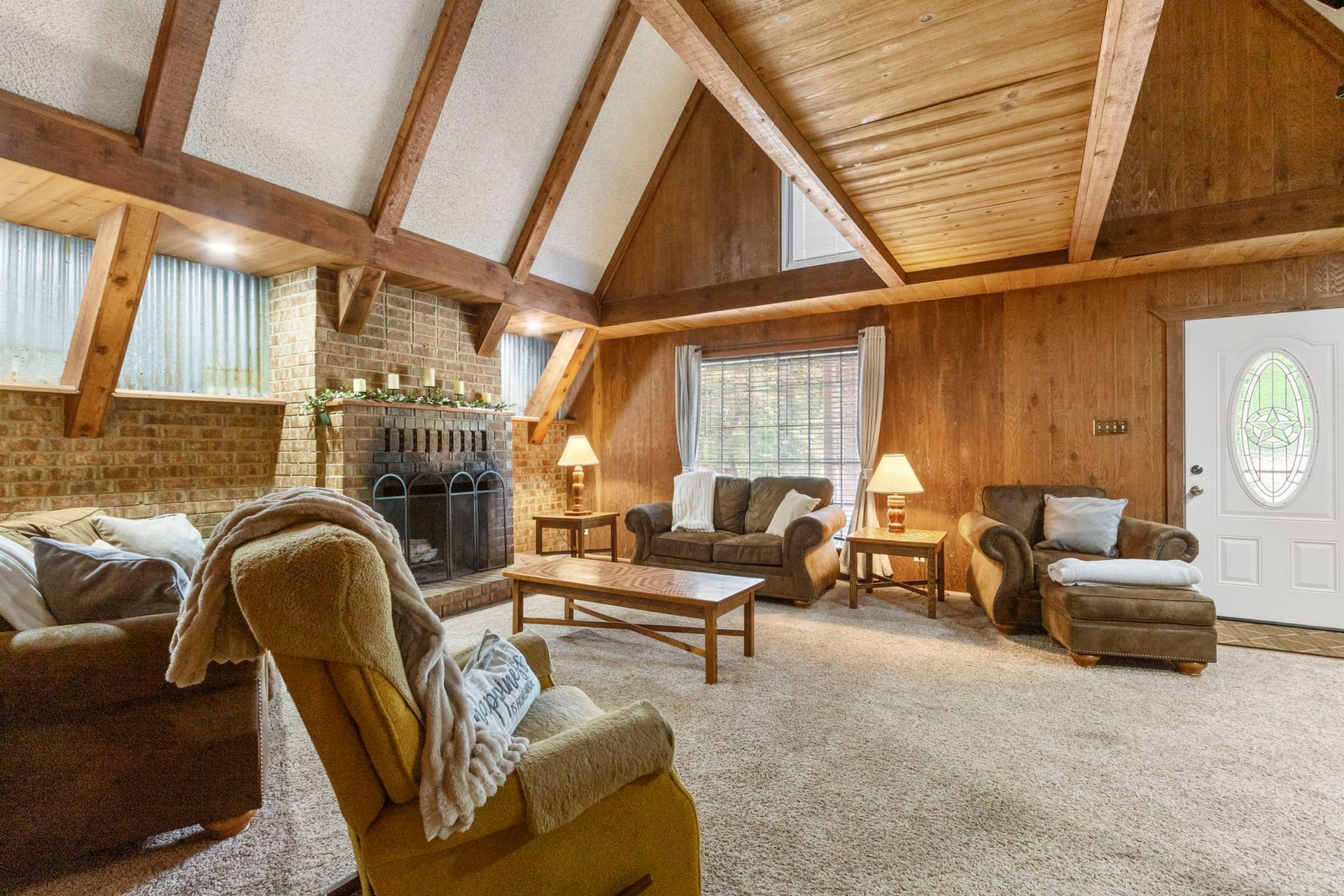 Character, warmth, and room to gather.
The spacious main living area features soaring ceilings and a wood-burning fireplace, creating an inviting place to relax, entertain, and feel right at home.