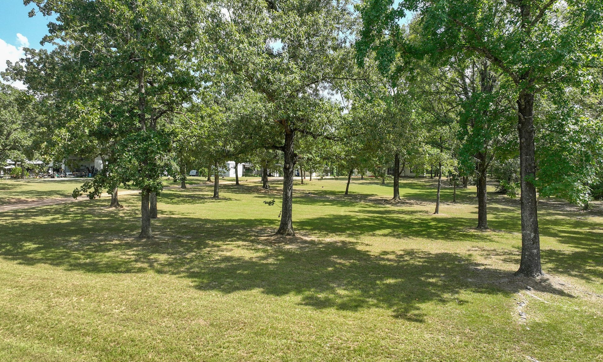 Enjoy a peaceful, park-like setting surrounded by mature trees and open acreage.