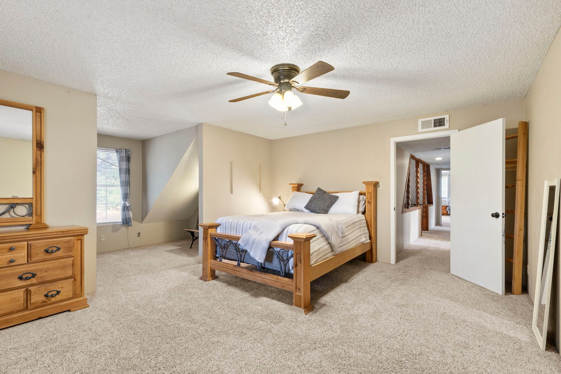 The split-bedroom layout offers two generously sized bedrooms upstairs and two bedrooms downstairs, providing plenty of space and flexibility throughout the main home