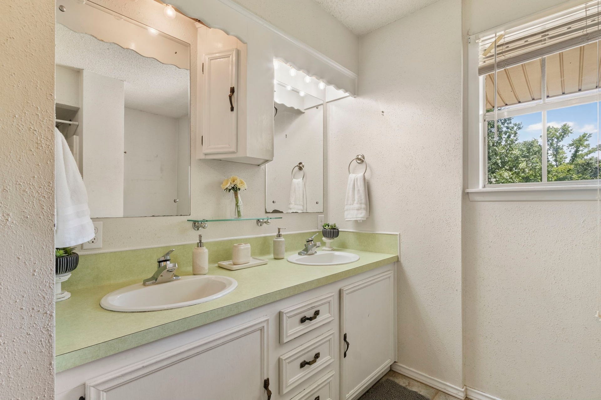 The upstairs full bathroom features dual sinks and a convenient shower and tub combination.