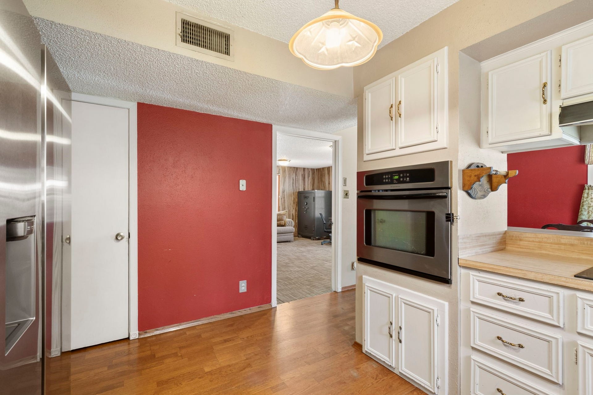 Designed for easy everyday living.
The kitchen offers convenient access to both the dining and living areas, while the door shown opens to a spacious walk-in pantry with plenty of storage.