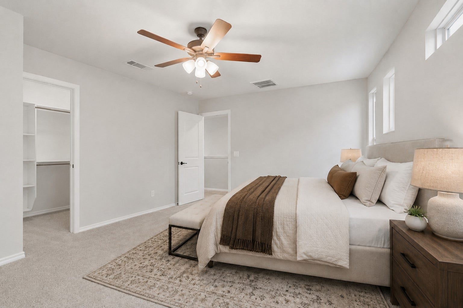 4028 Starbright Street, Houston, TX 77018 Alternate view of primary bedroom features neutral-toned walls, soft carpeting, a ceiling fan, and an open doorway leading into a walk-in closet.**Virtually staged