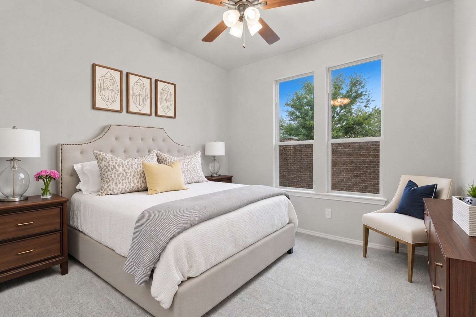 4028 Starbright Street, Houston, TX 77018 Comfortable first-floor bedroom features plush neutral carpeting, a classic ceiling fan, and large twin windows that fill the space with natural light.**virtually staged
