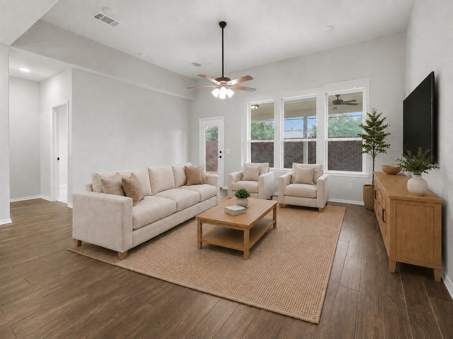 4028 Starbright Street, Houston, TX 77018 This spacious living area features durable wood-look tile flooring, a recessed ceiling fan, large windows, and direct backyard access.**Virtually staged