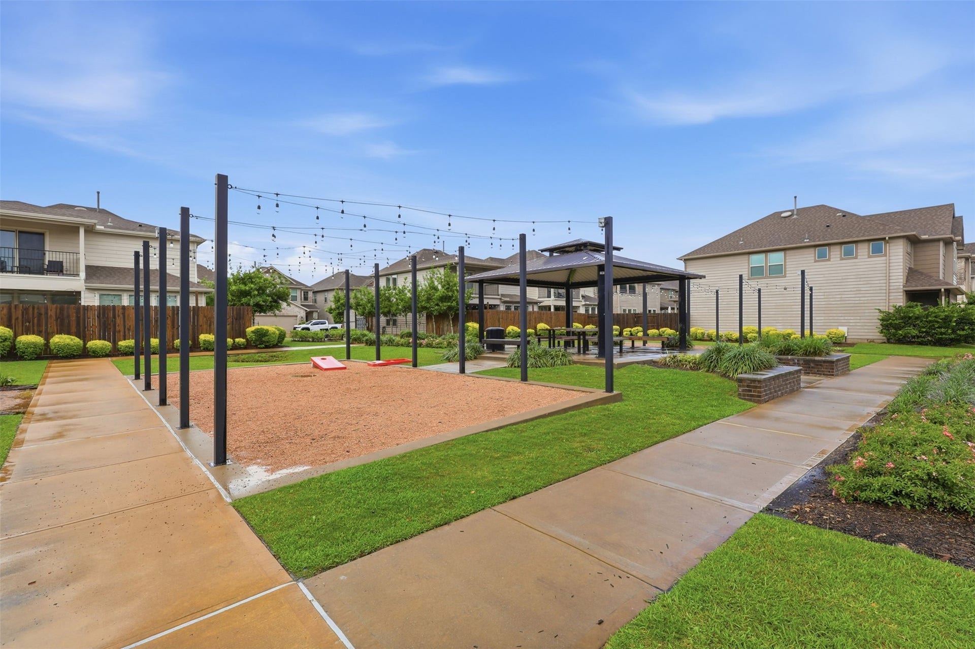 4028 Starbright Street, Houston, TX 77018 A dedicated gravel court with overhead string lighting poles offers a ready-made space for evening games and outdoor entertainment.