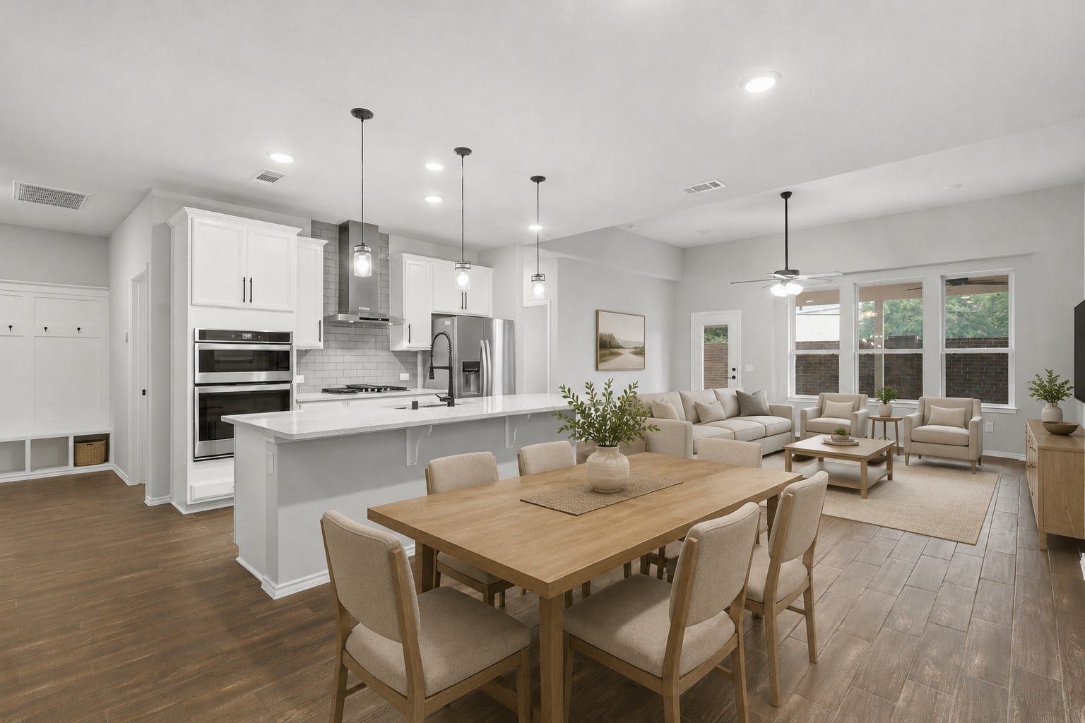 4028 Starbright Street, Houston, TX 77018 The expansive, open-concept layout seamlessly connects the living space to a modern kitchen equipped with white cabinetry and a large central island.**Virtually staged