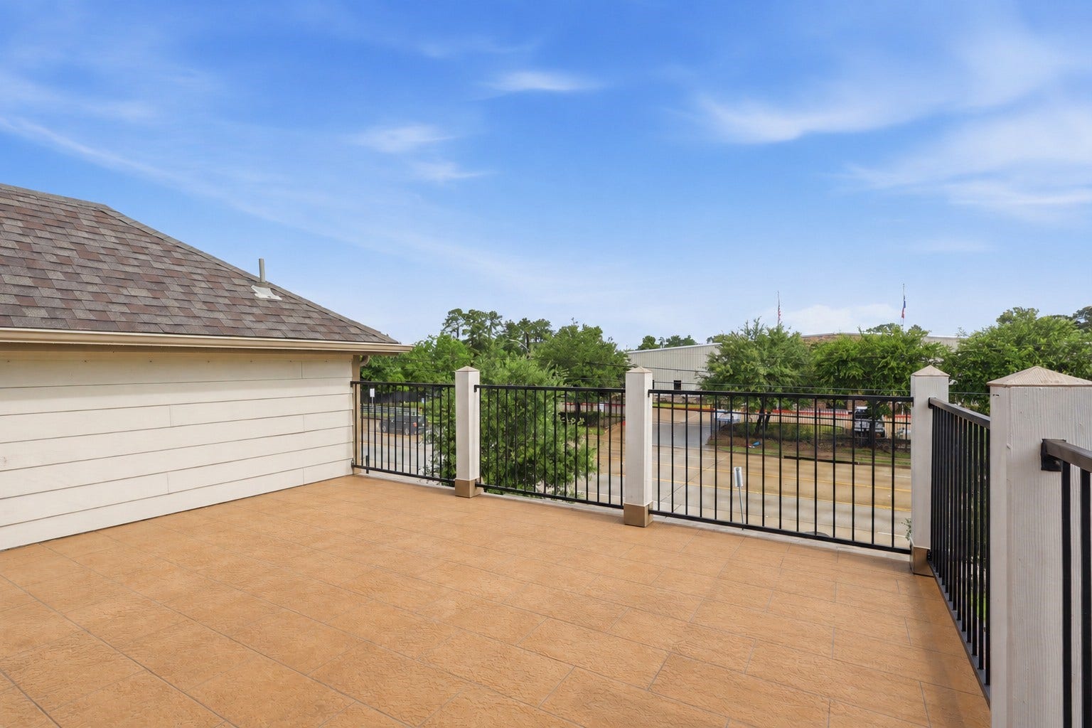 4028 Starbright Street, Houston, TX 77018 The spacious second-story rooftop deck is finished with textured outdoor tiles and a sturdy black metal balustrade.