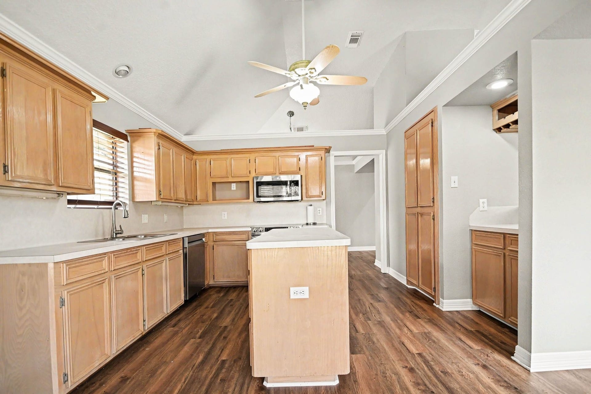 Large kitchen with island, stainless steel appliances, custom cabinetry, and plenty of counter space for all the cooking