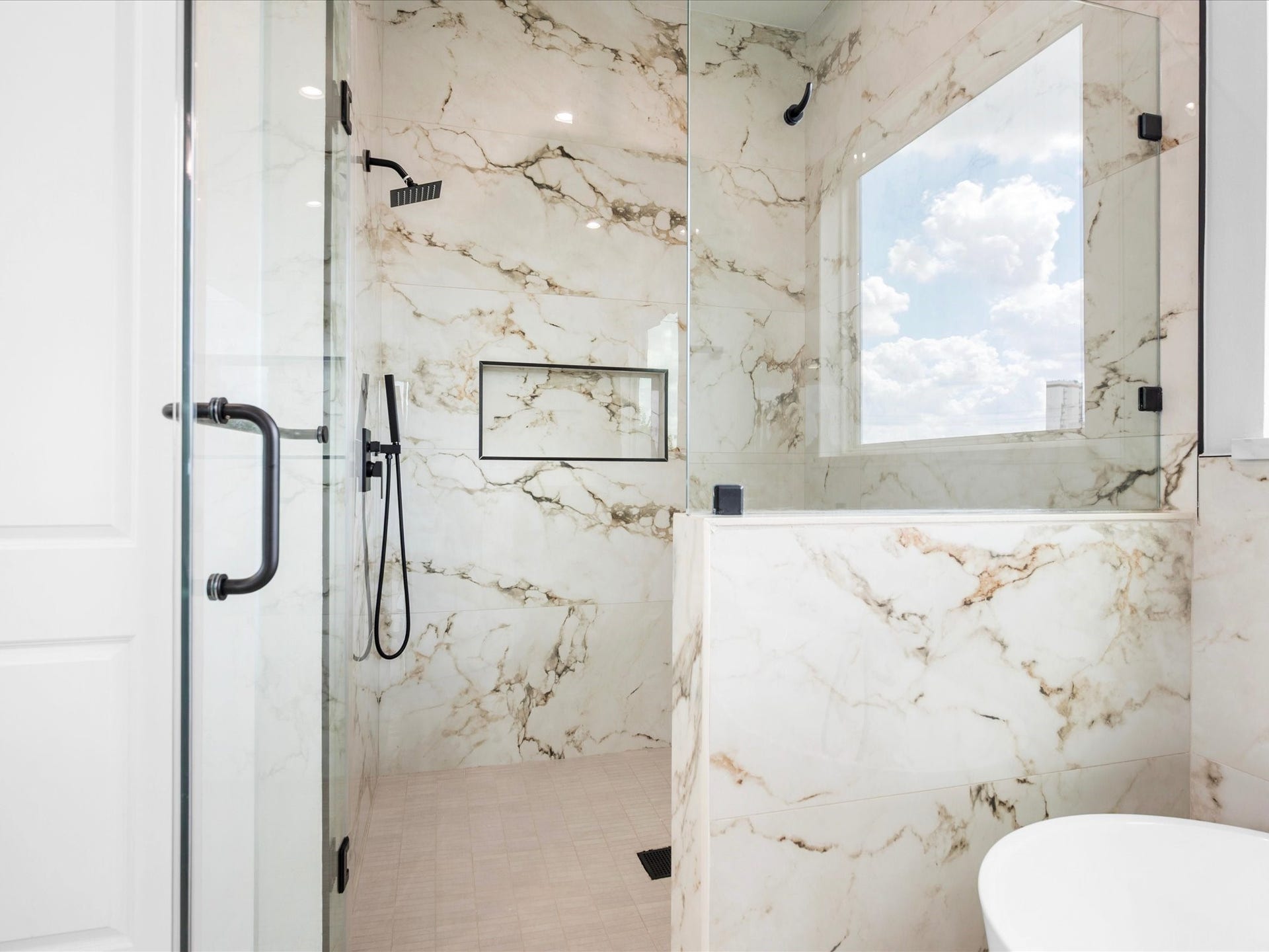 120 Estelle Street, Houston, TX 77003 Beautifully detailed tilework elevates the primary shower, adding a refined touch to the ensuite.