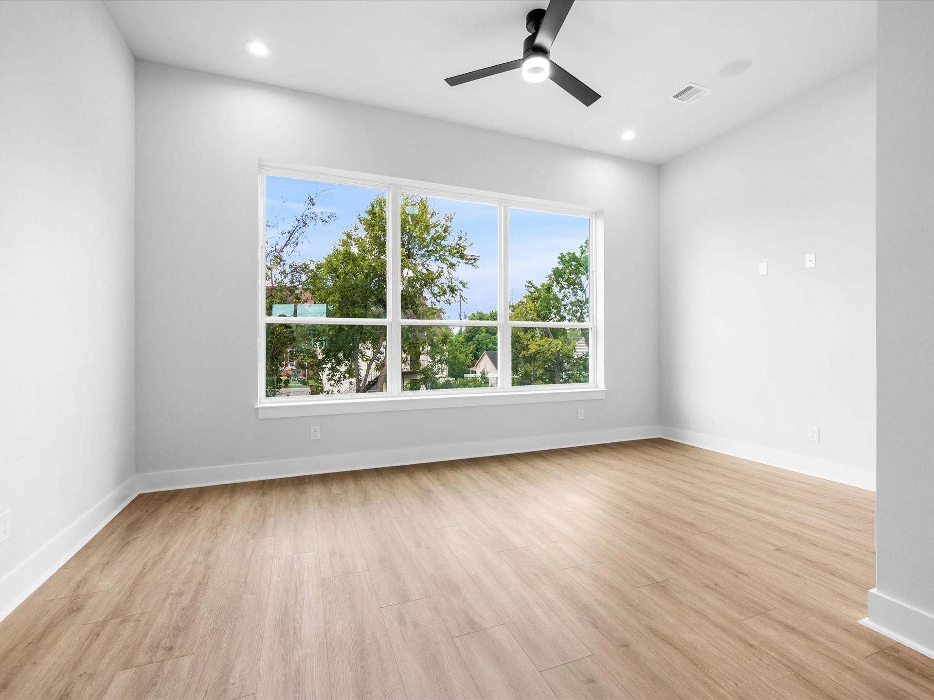 120 Estelle Street, Houston, TX 77003 Expansive windows bring natural light into the living area, creating a bright, inviting space that complements the home's clean lines and modern design