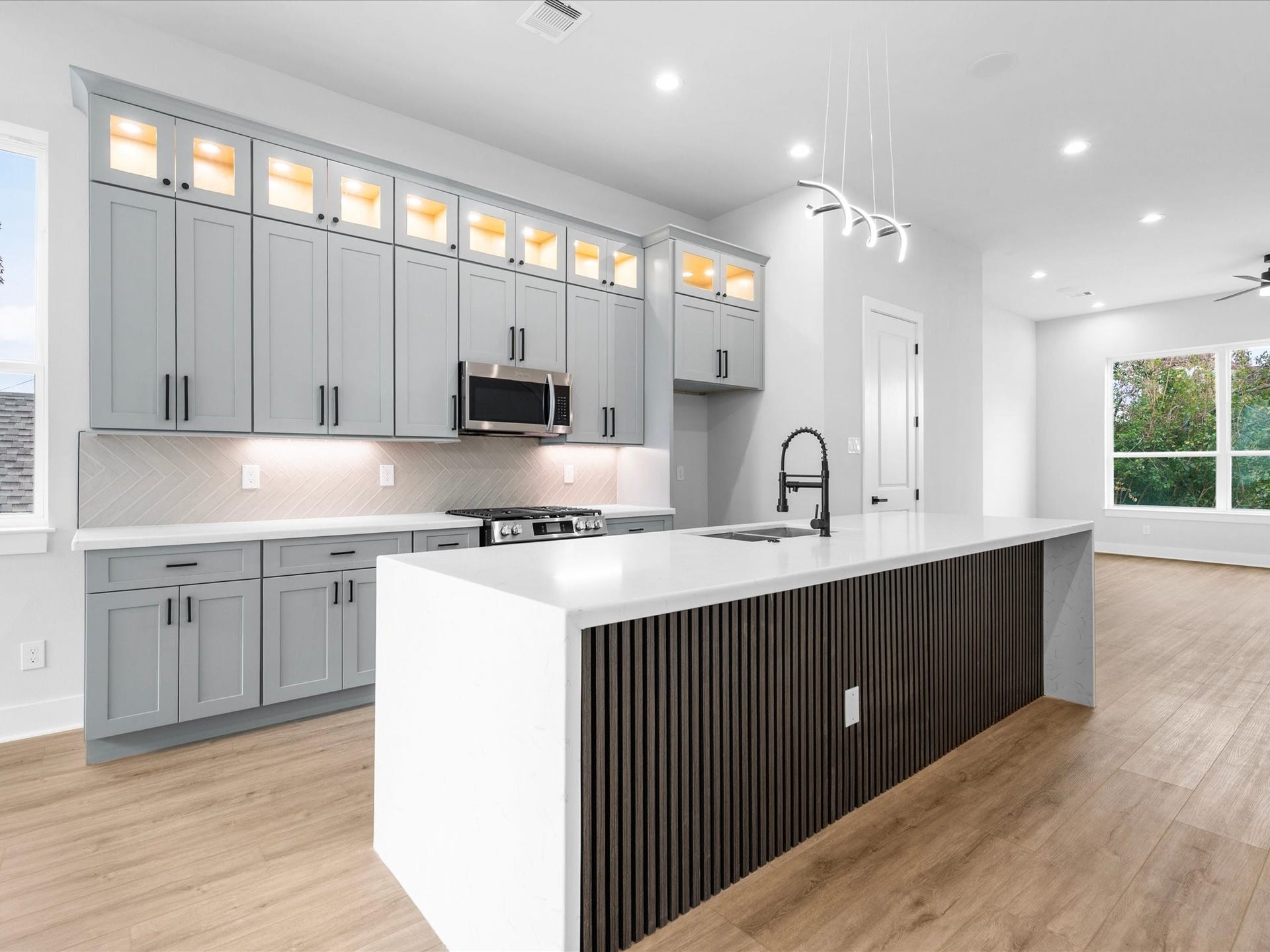 120 Estelle Street, Houston, TX 77003 Quartz countertops and streamlined cabinetry contribute to the kitchen's clean, modern aesthetic, creating a sophisticated backdrop for daily routines and hosting guests.