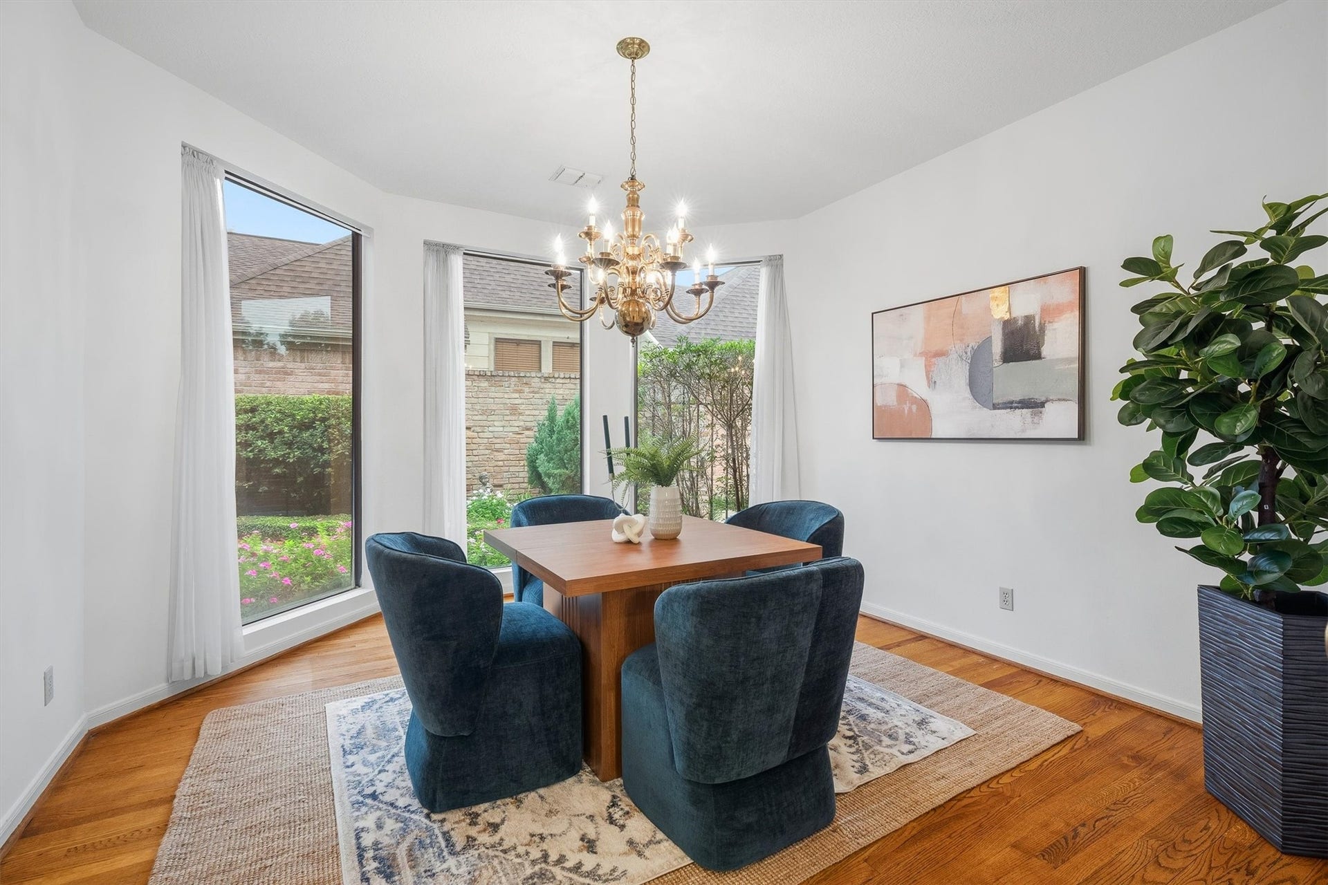 12219 Ravenmoor Drive, Houston, TX 77077 Elegant dining room with large windows offering abundant natural light, featuring a sophisticated chandelier.