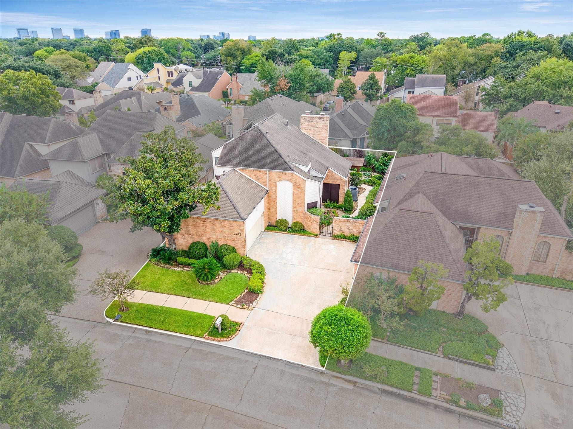 12219 Ravenmoor Drive, Houston, TX 77077 Attractive home with a modern facade, nestled in a lush neighborhood, featuring a spacious driveway and well-maintained landscaping.